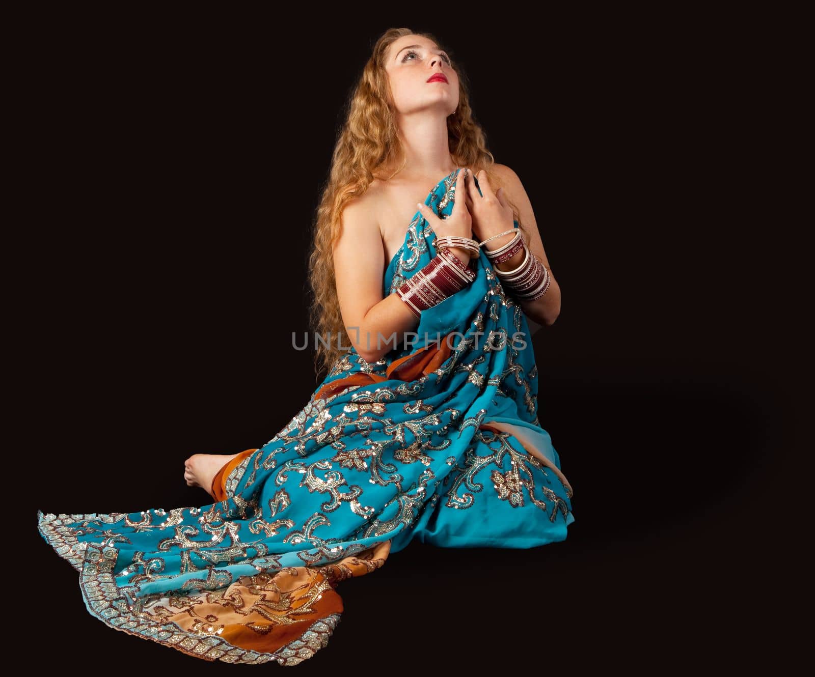 girl sit in oriental costume with passion emotion in dark