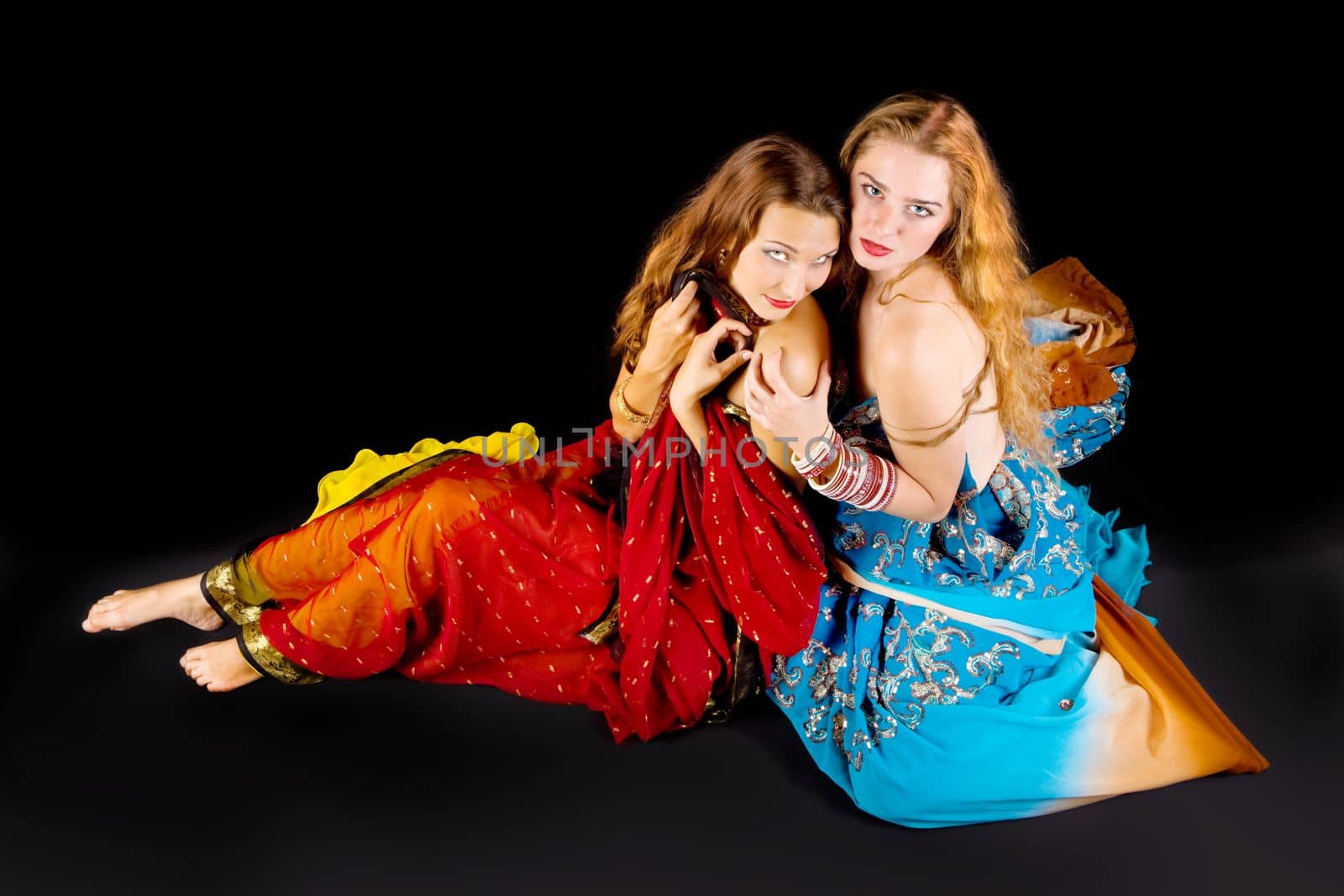 two young attractive woman look at you in indian costume