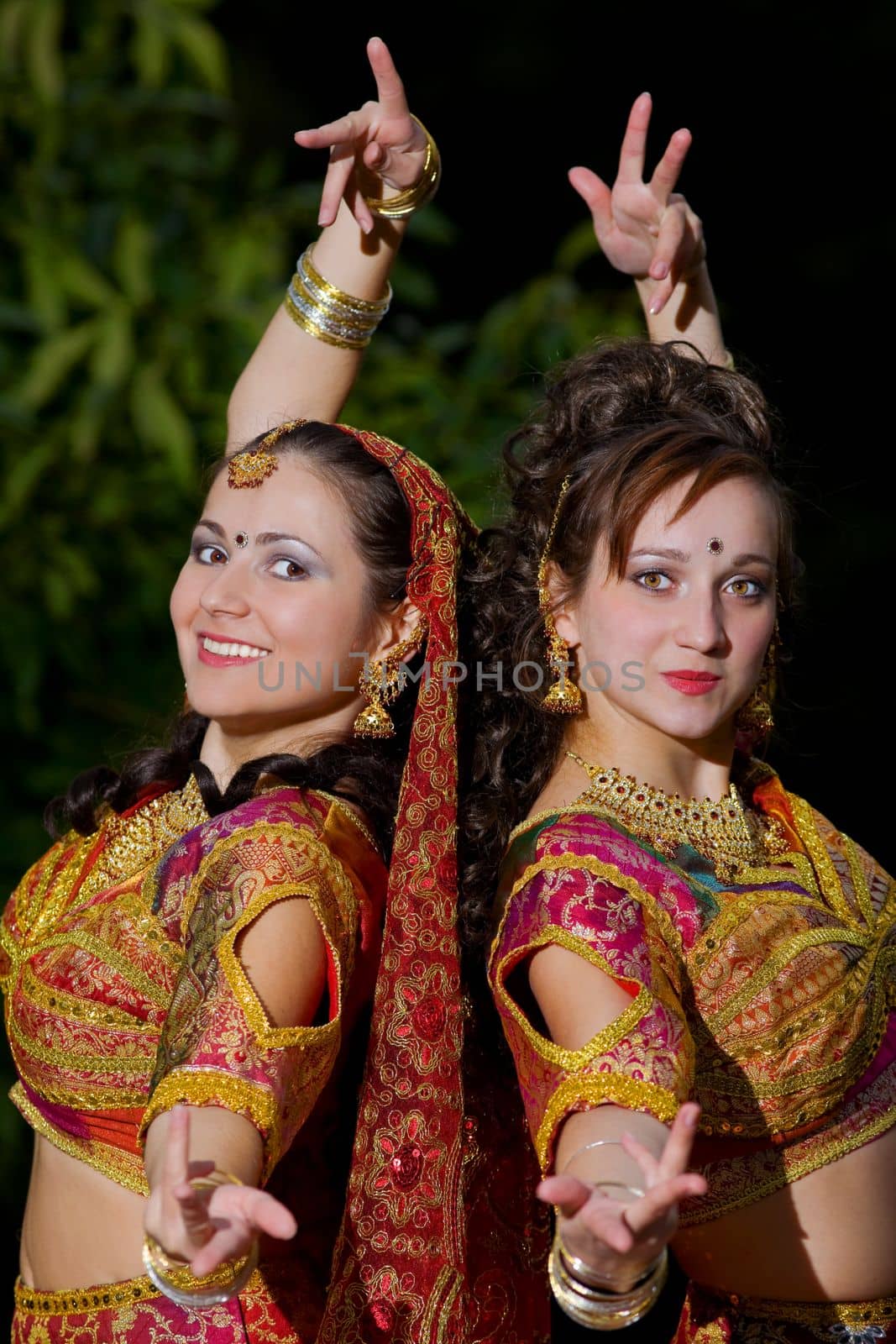 two young woman dance - traditional indian costume