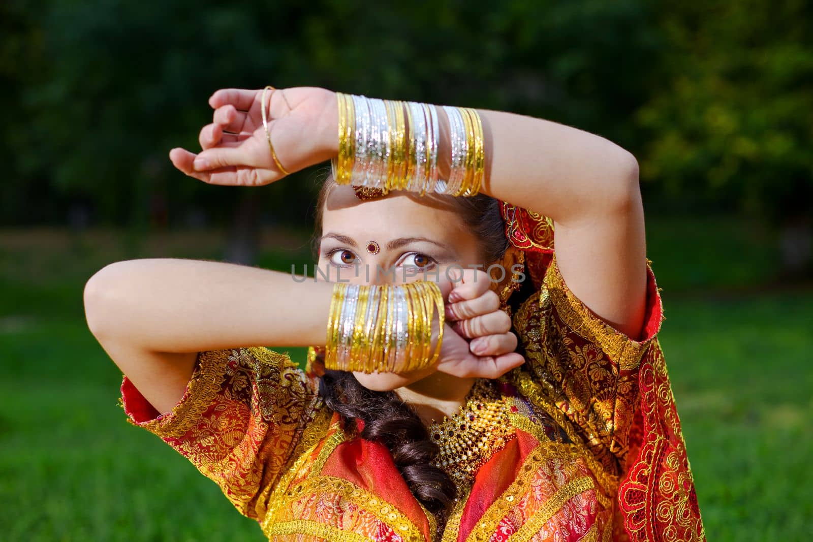 A young Indian woman hiding face with hands