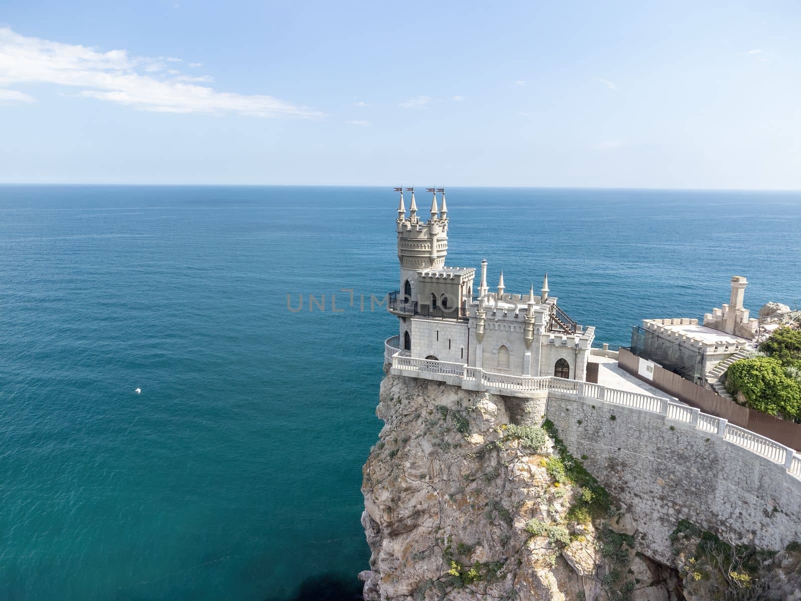 Aerial view of Swallow's Nest castle on the rock in Black Sea. It is a symbol and landmark of Crimea. Beautiful scenic panorama of the Crimea coast. Amazing Swallow's Nest at the precipice.
