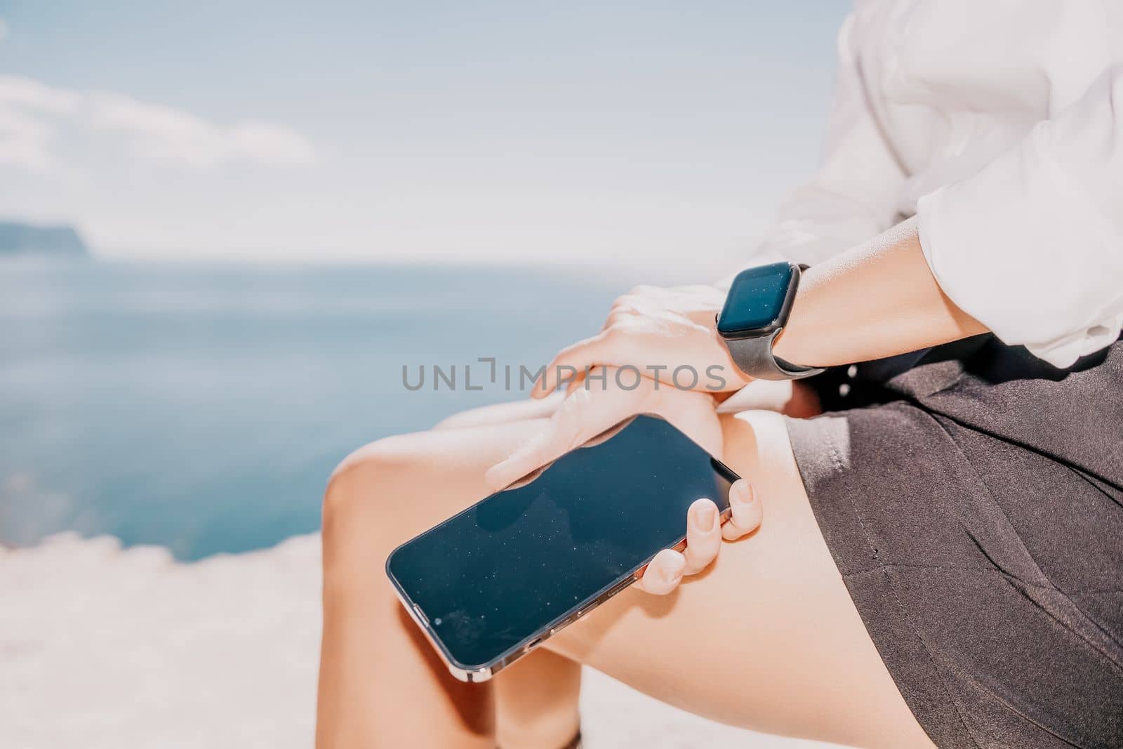 Woman sea laptop. Business woman in yellow hat freelancer with laptop working over blue sea beach. Girl relieves stress from work. Freelance, digital nomad, travel and holidays concept by panophotograph