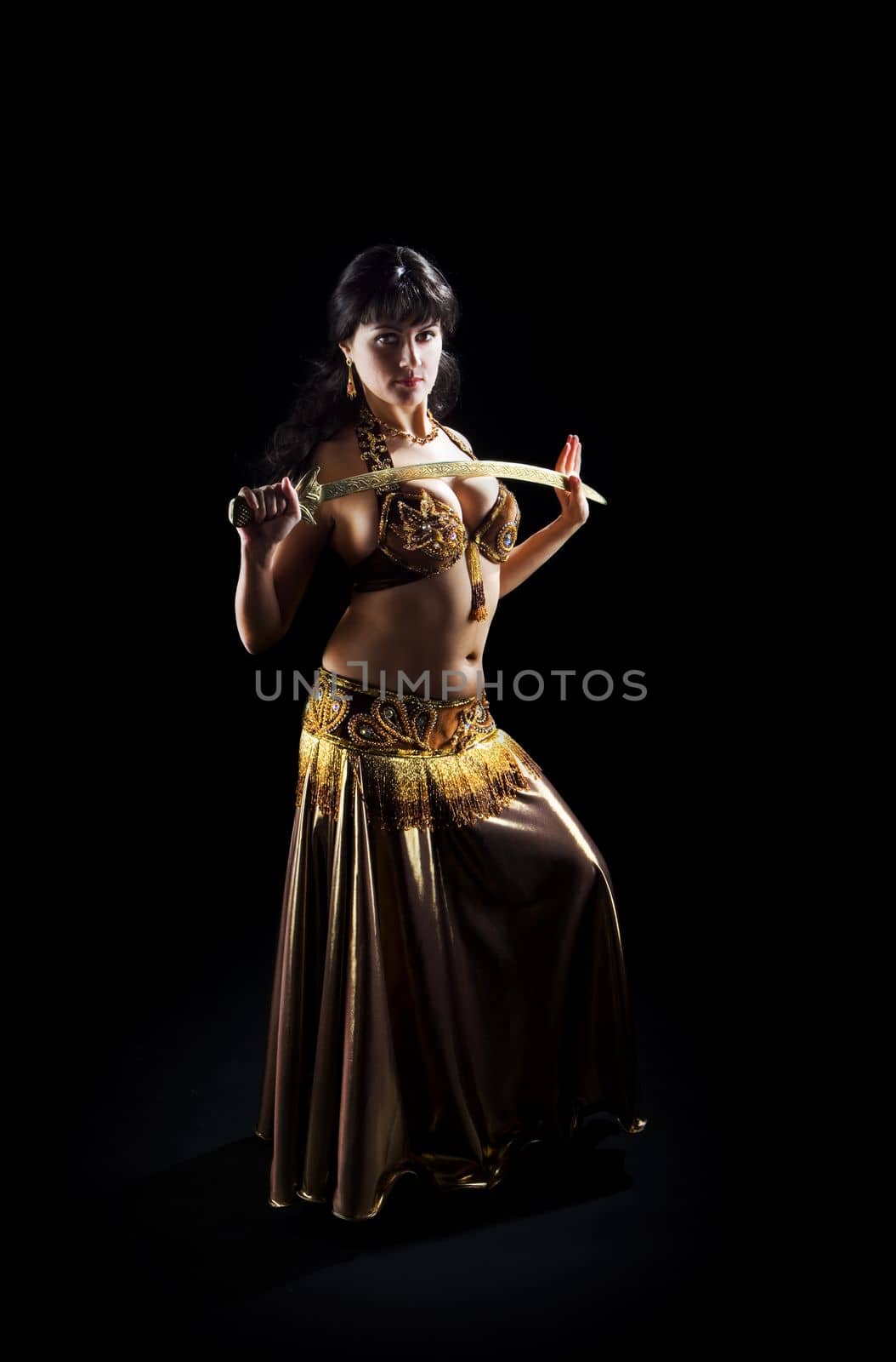 beautiful arabic brunette woman dance with sword