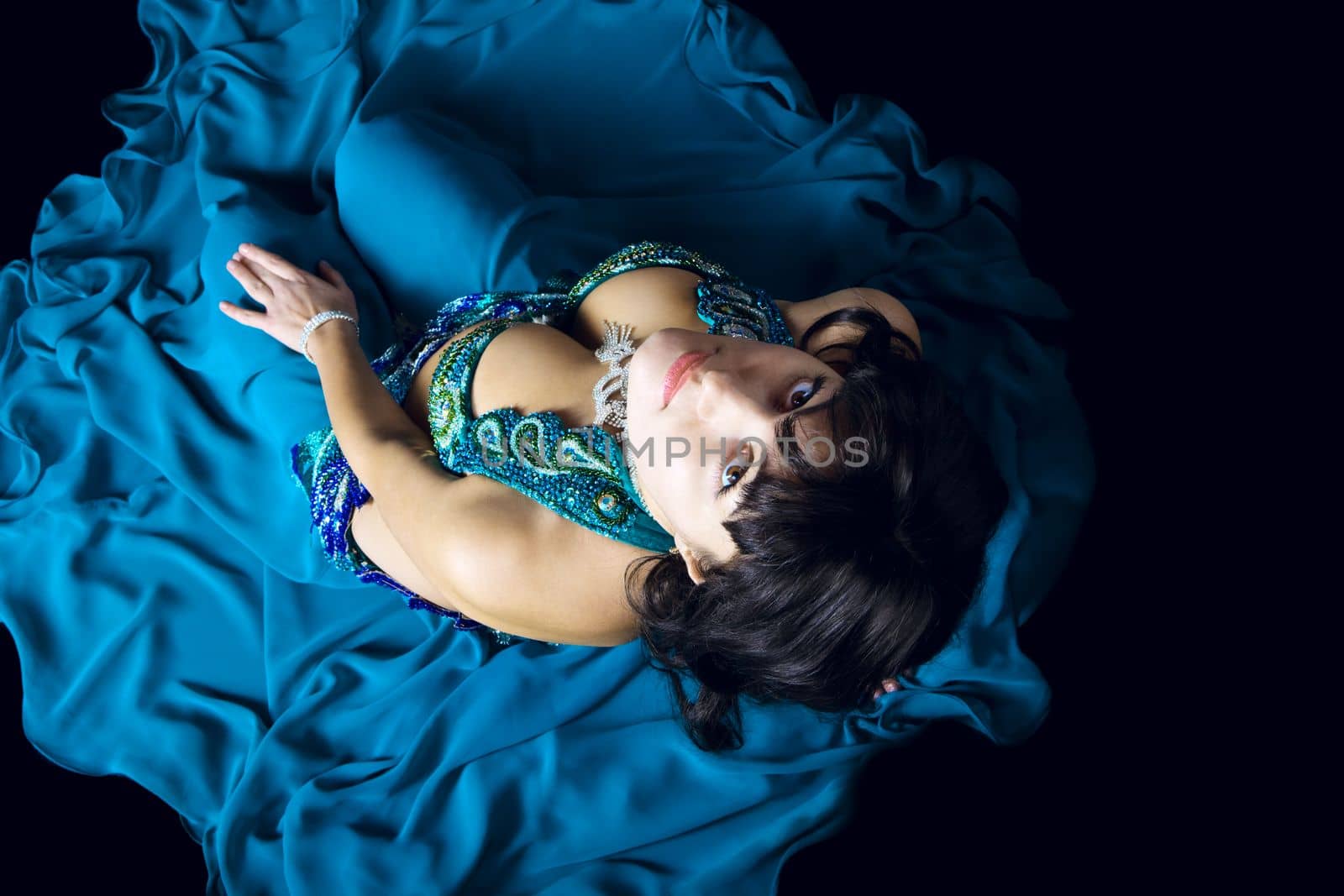 woman in blue costume look at you