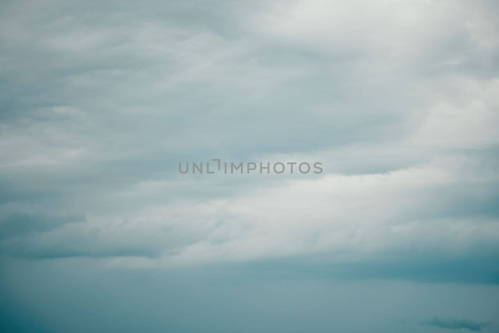 Overcast sky on rainy day with Nimbostratus clouds. Gloomy and moody background. Overcast clouds. Bad weather. Sad and depressed background. by panophotograph