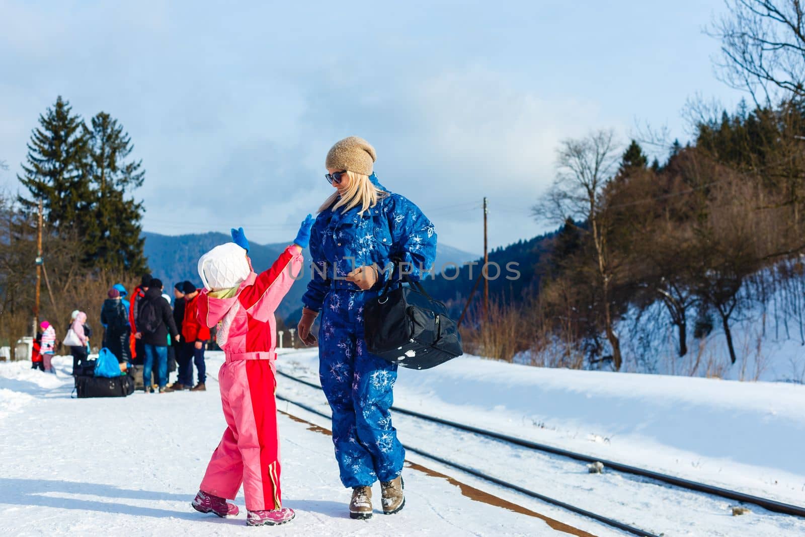 daughter and mother on the platform of winter.