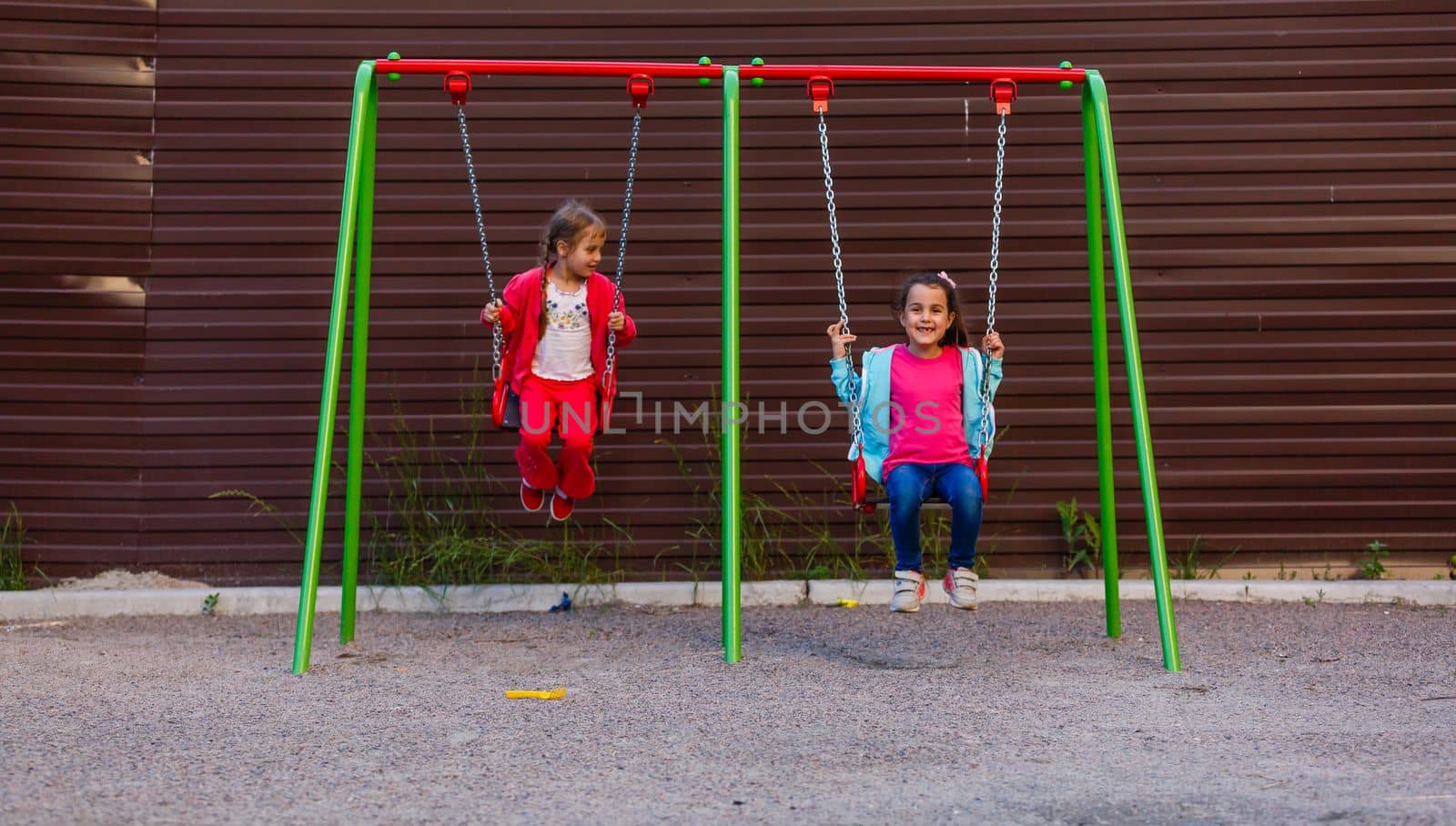 Happy little girl on swing