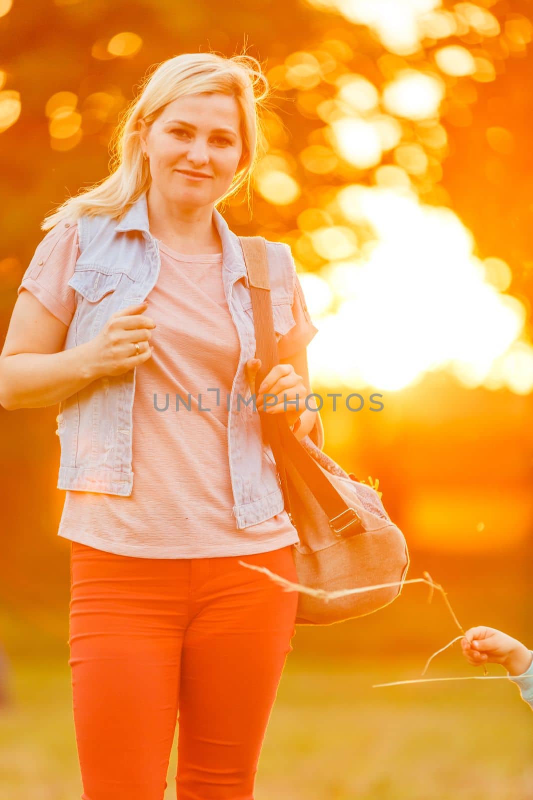 Young woman on field over sunset.