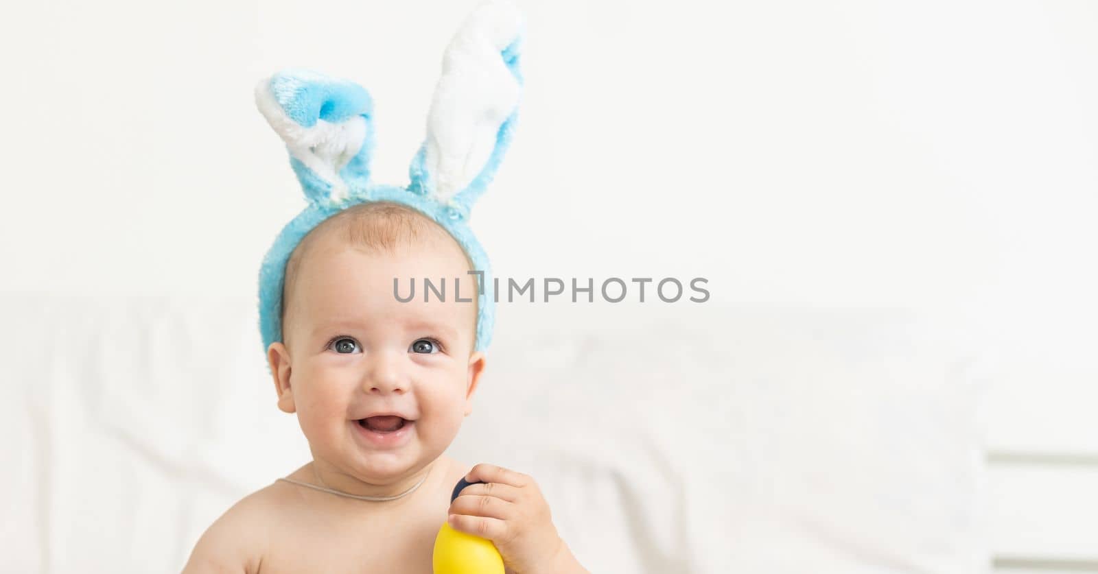 Boy dressed as bunny and Easter eggs.