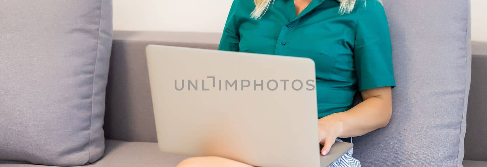 A young smiling woman wearing red Santa Claus hat making video call on social network with family and friends on Christmas day by Andelov13