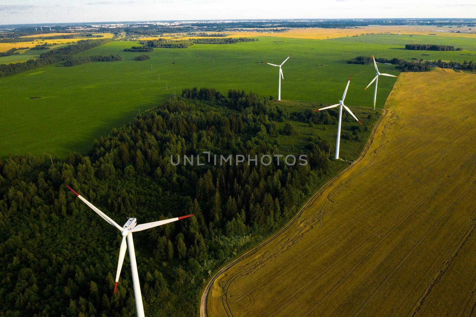 Windmills on the background of forests and fields. Windmill in nature.Belarus by Lobachad