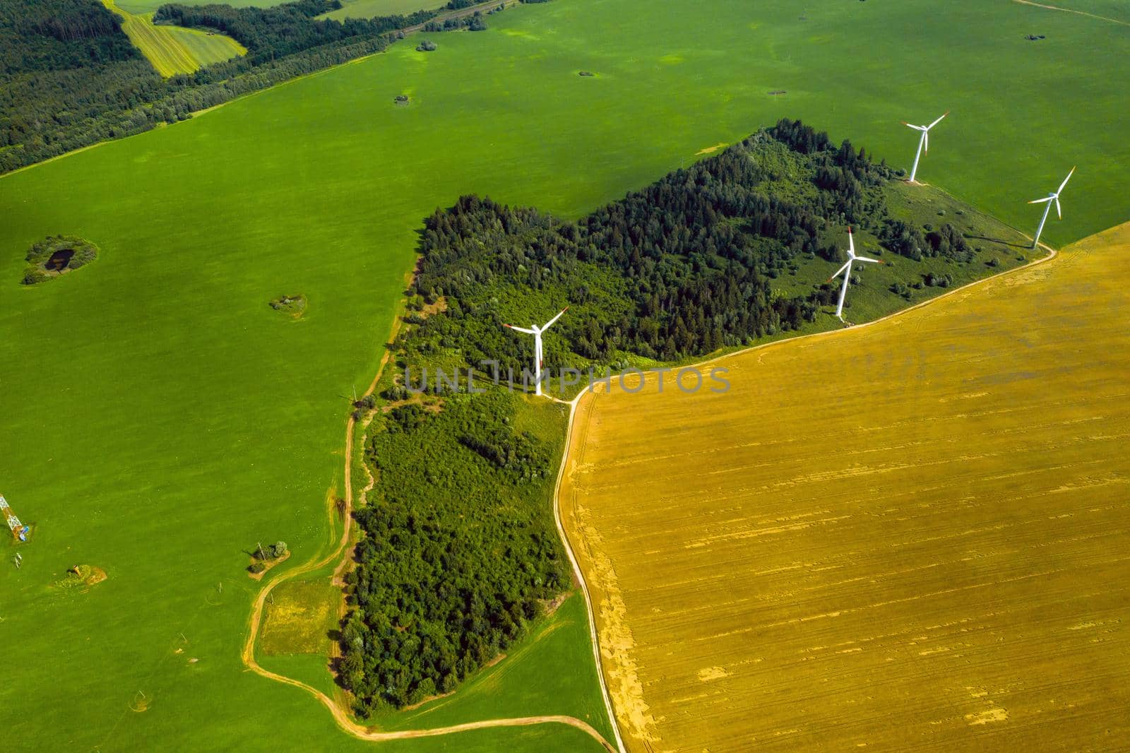 Windmills on the background of forests and fields. Windmill in nature.Belarus by Lobachad