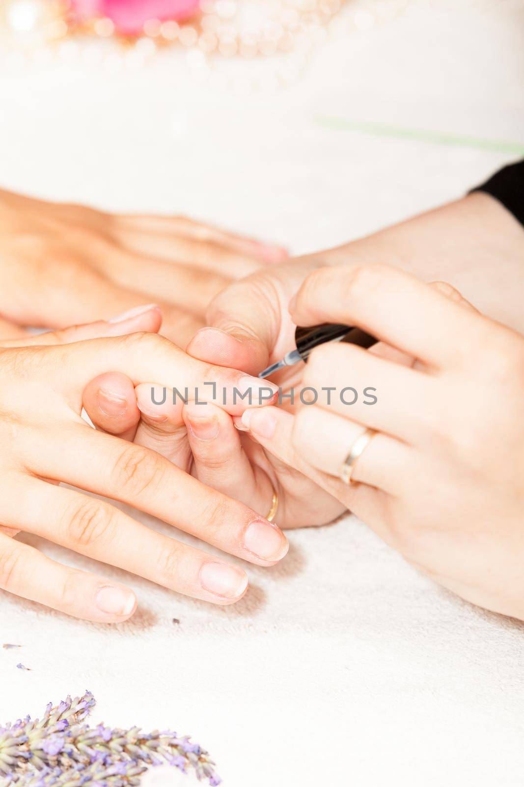 Laying nail polish on a woman's hands