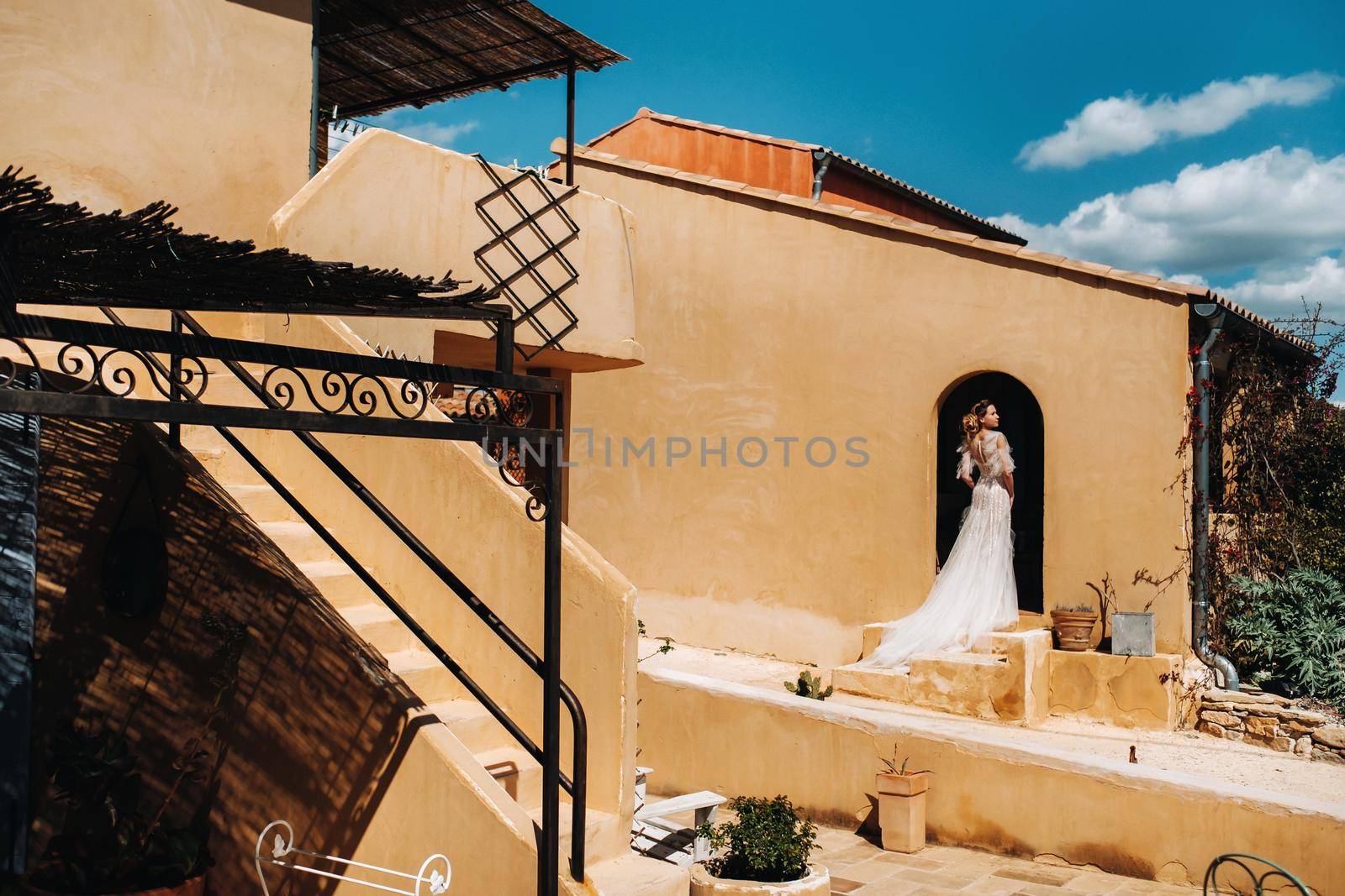 a beautiful bride with pleasant features in a wedding dress is photographed in Provence. Portrait of the bride in France by Lobachad