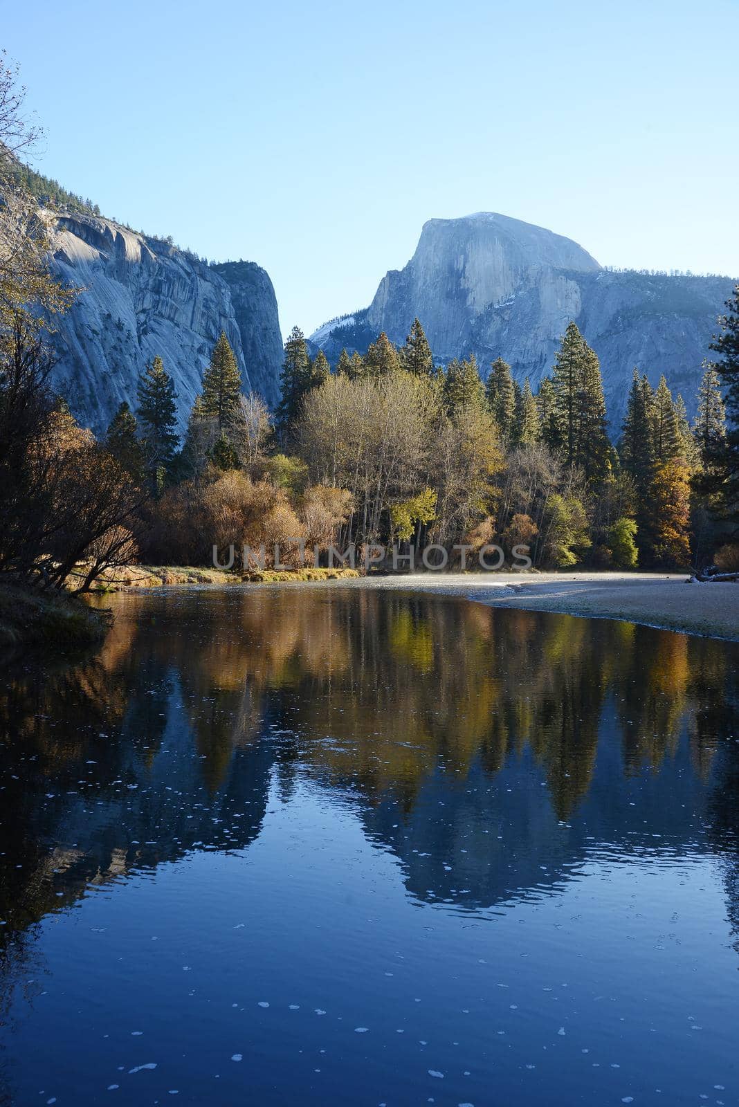 a reflection of half dome of yosemite over merced river