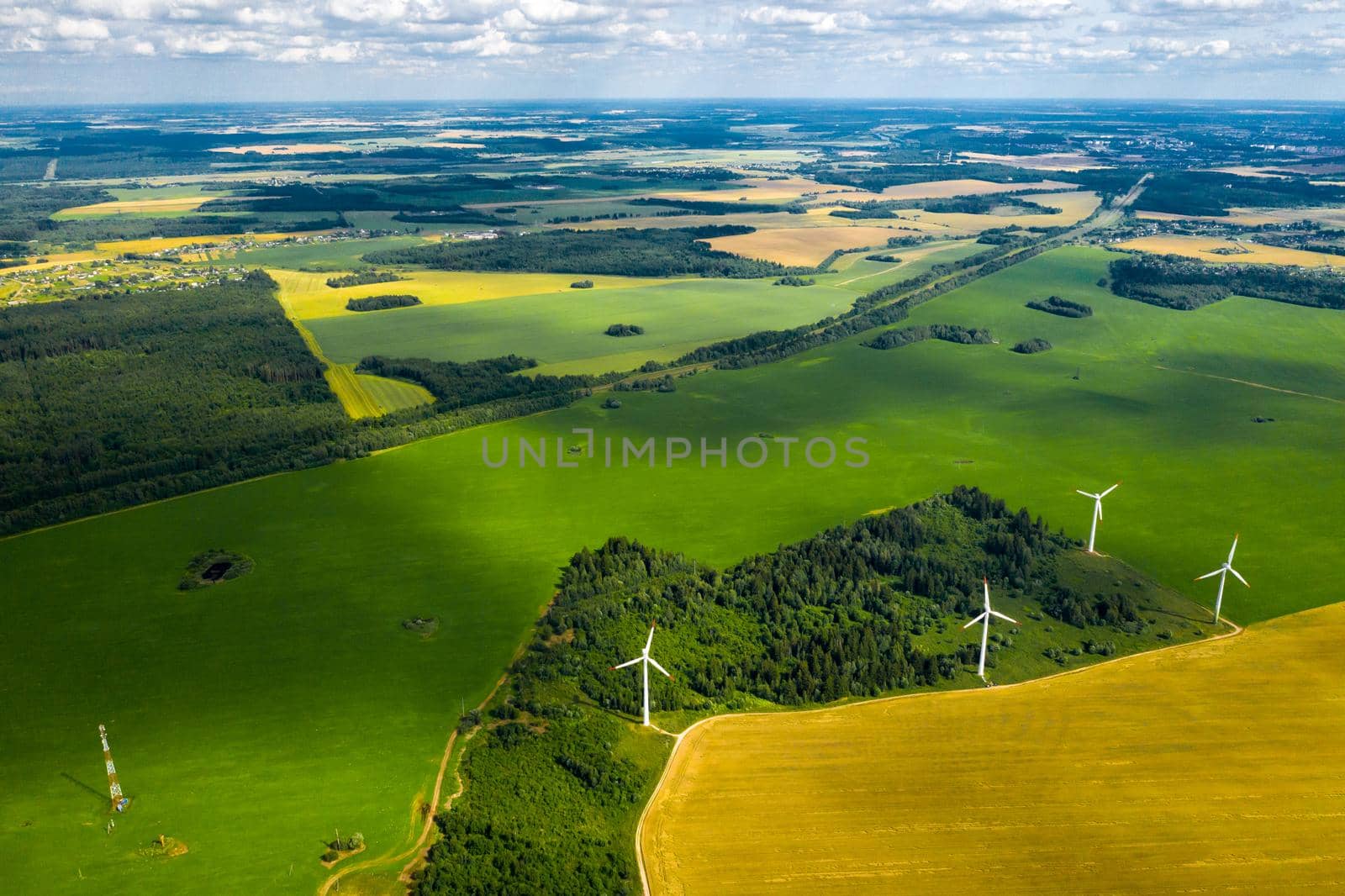 Windmills on the background of forests and fields. Windmill in nature.Belarus by Lobachad