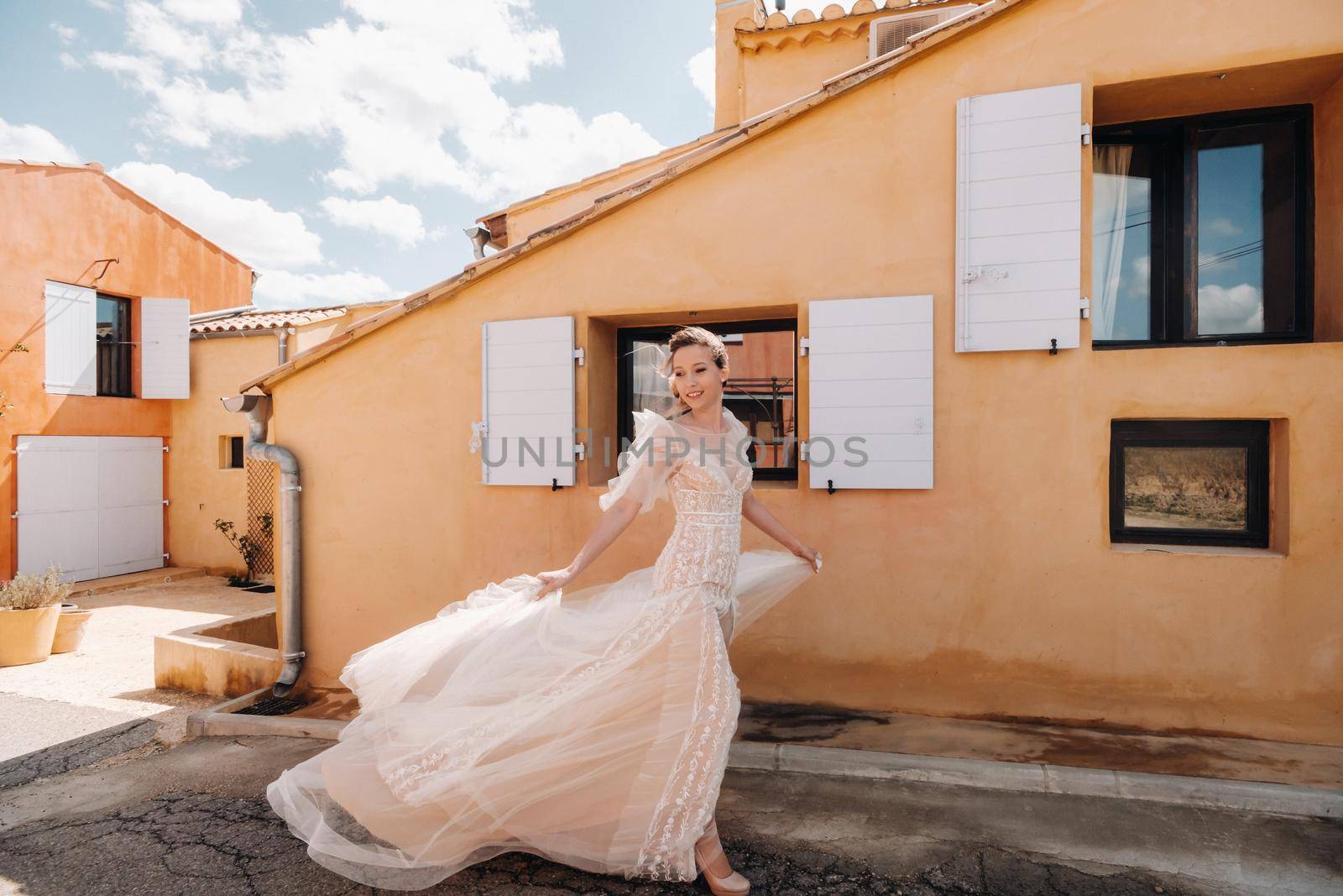 a beautiful bride with pleasant features in a wedding dress is photographed in Provence. Portrait of the bride in France.