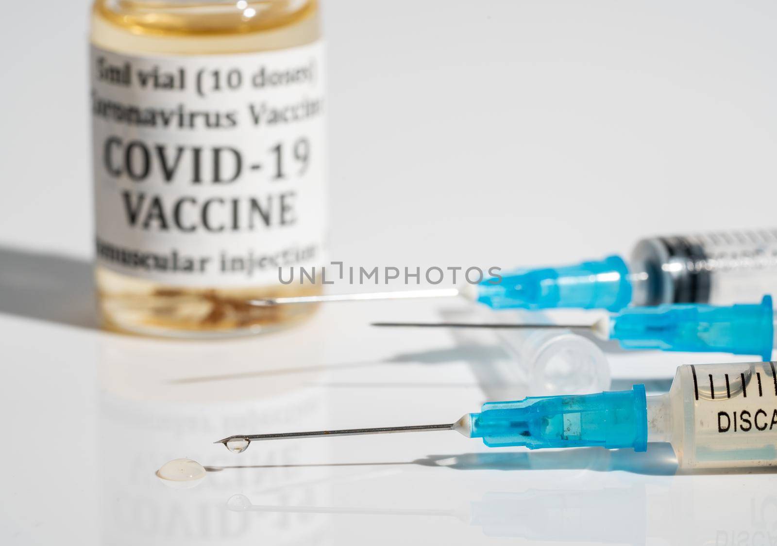 Concept for booster vaccination with three syringes with the third representing the boost for the Covid-19 vaccine