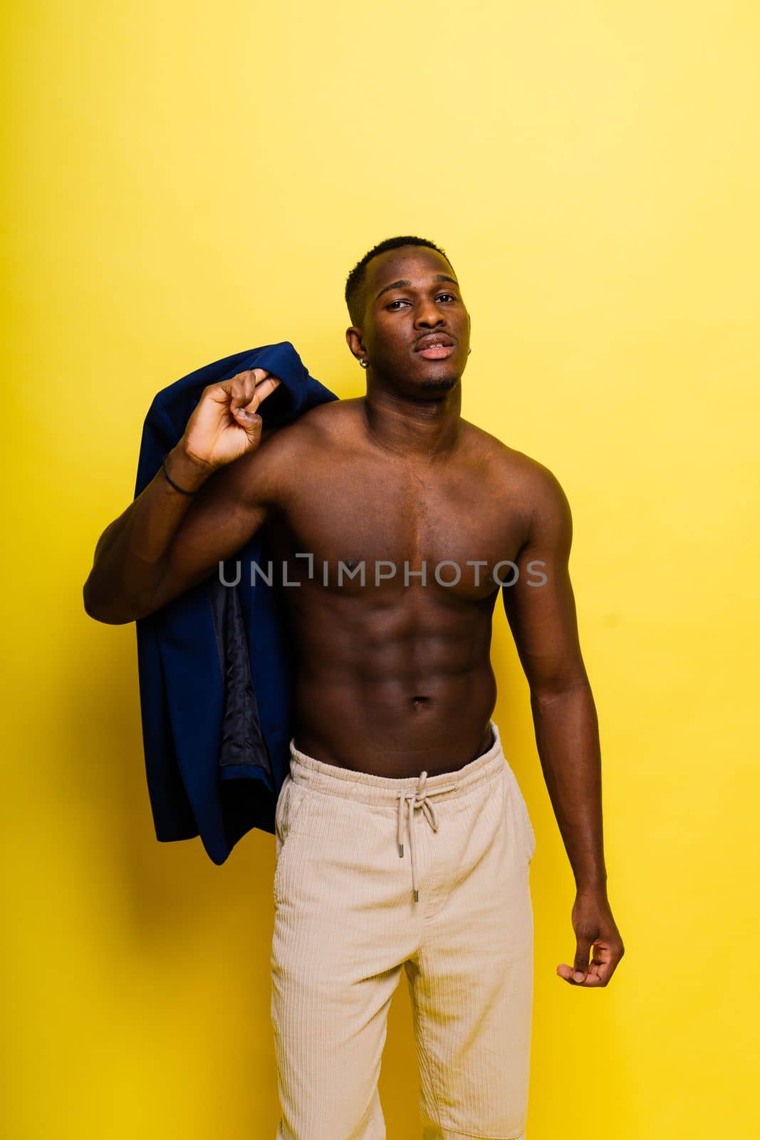 Smiling young african american man guy isolated on yellow background studio. People sincere emotions by Zelenin