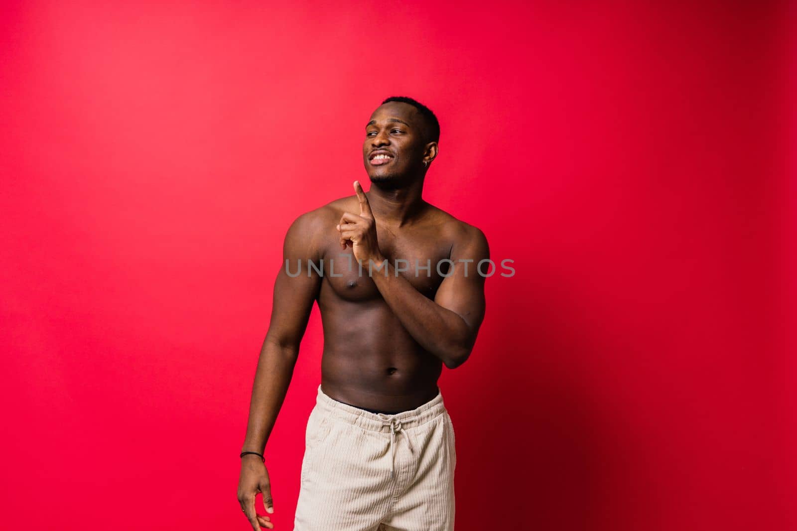 Smiling young african american man guy isolated on yellow background studio. People sincere emotion