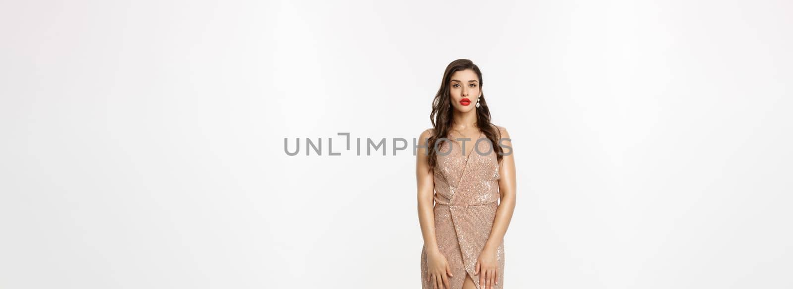 Christmas party and celebration concept. Full length shot of elegant brunette woman in stylish dress posing over white background by Benzoix