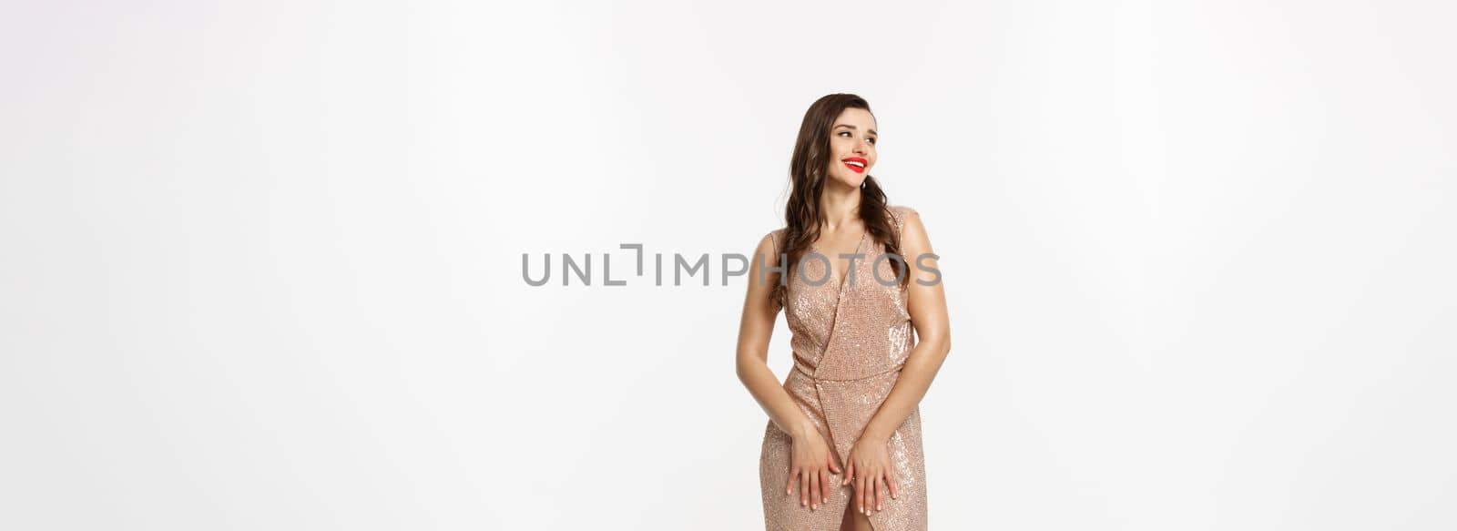 Christmas party and celebration concept. Full length shot of elegant brunette woman in stylish dress posing over white background.