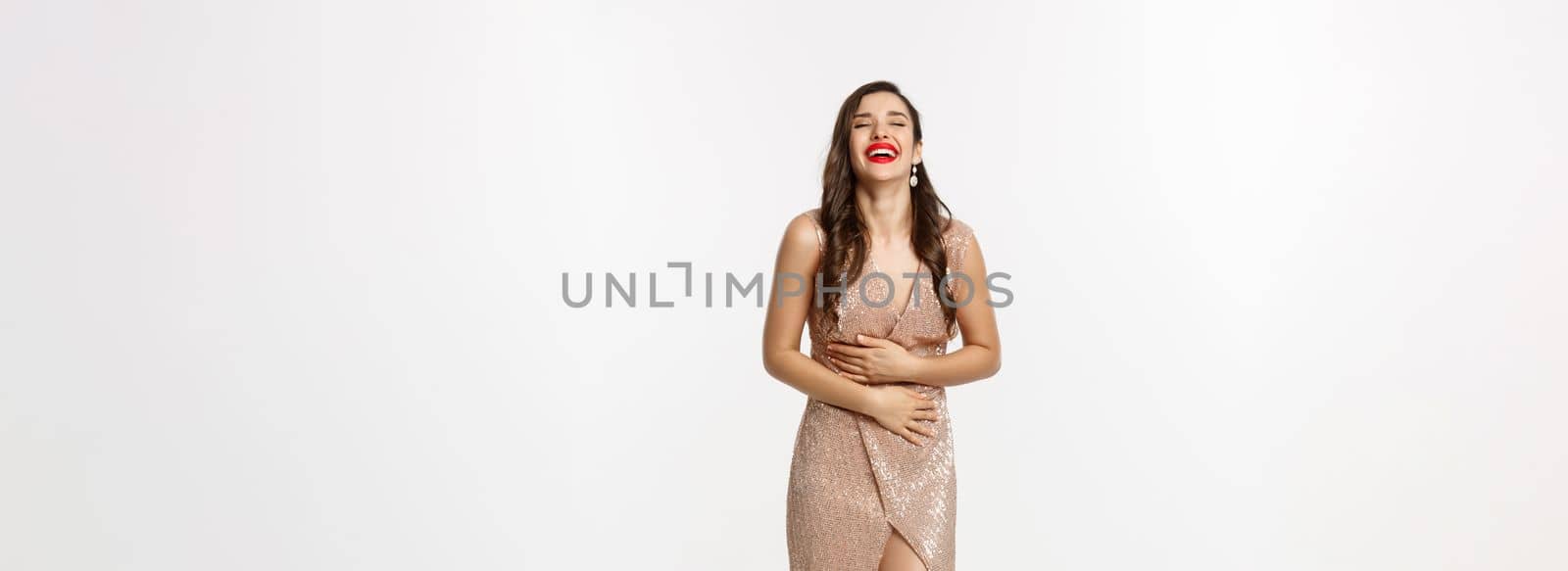 Party and celebration concept. Full-length of elegant woman with red lips, standing near Christmas gifts and laughing happy, standing over white background.