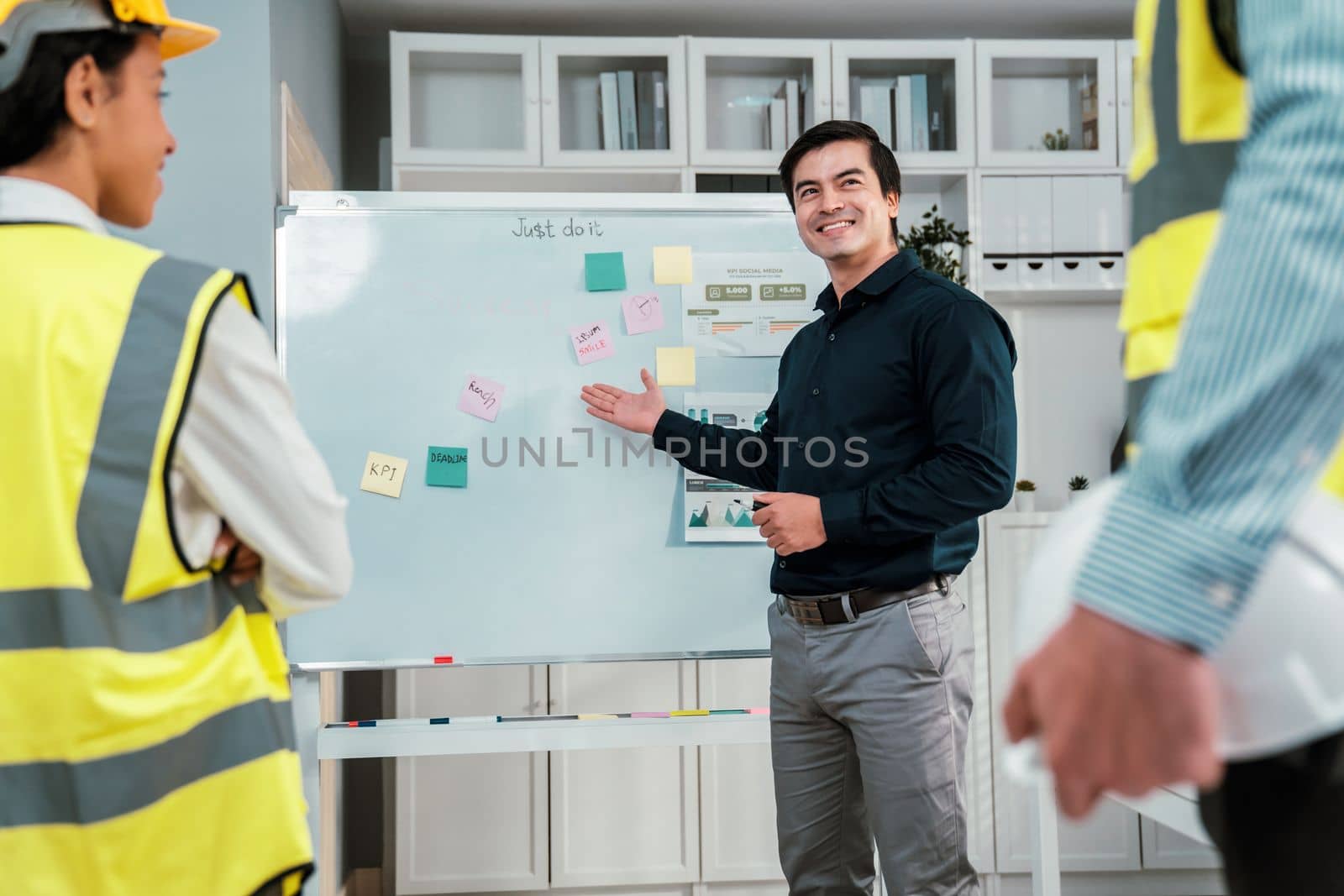 Entrepreneur brainstorming ideas with his competent engineers in the office. Architectural investors and engineers working on an upcoming project in a fun and friendly environment.