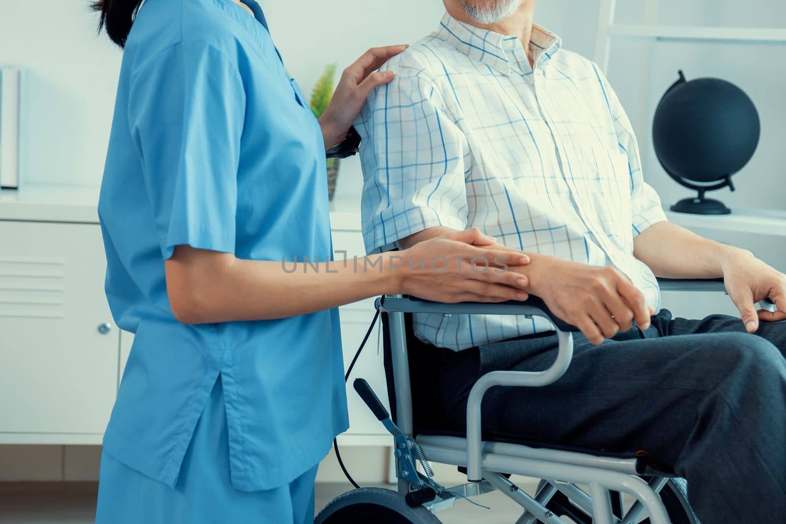 Happy positive asian nurse giving support and touching contented senior man with love. Nursing home for the elderly, elderly health and illness, senior patient carer.