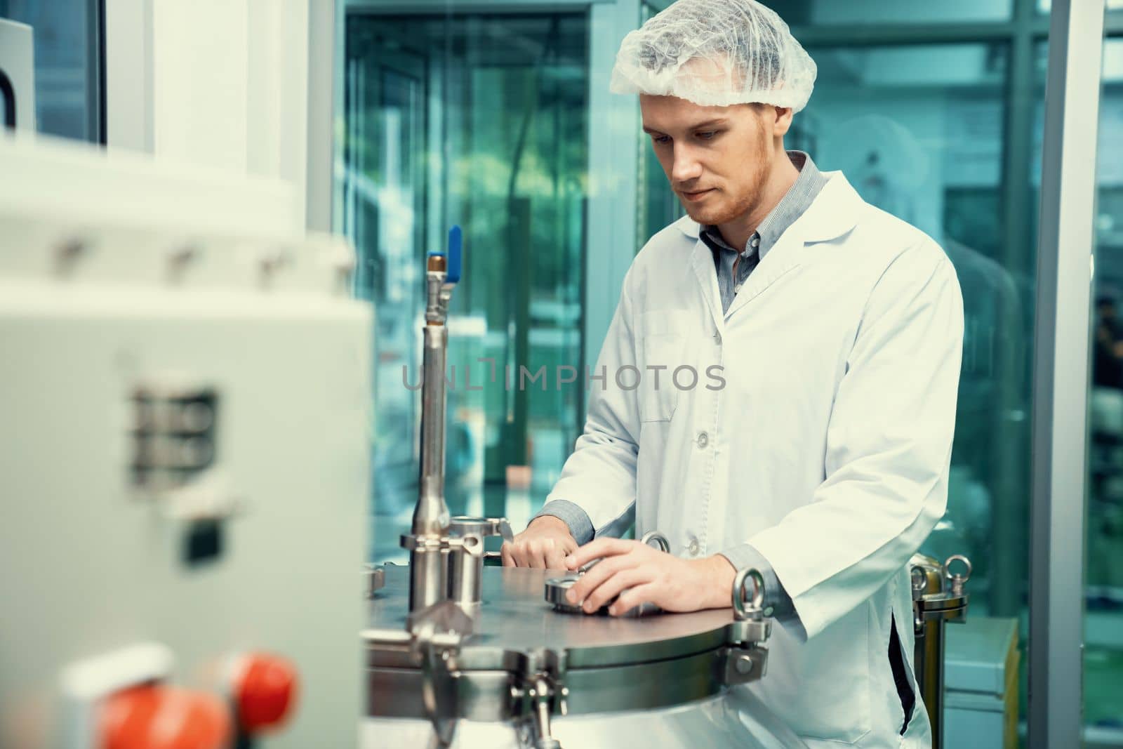 Portrait of a scientist, apothecary extracting cannabis oil using scientific equipment in a laboratory. Concept of cannabis extraction for alternative medicinal treatment. CBD oil extraction concept.