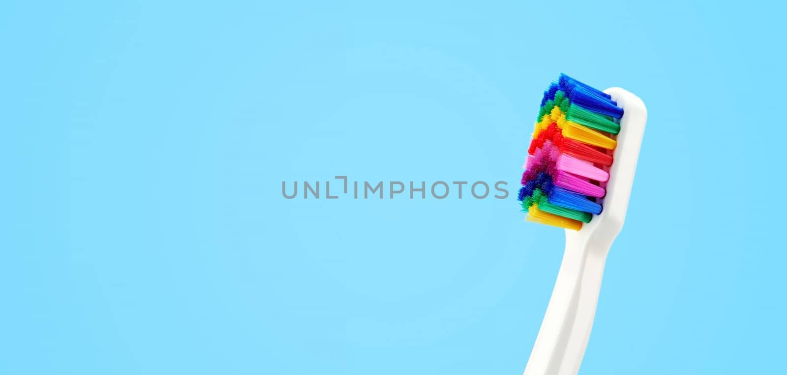 White toothbrush with multicolored bristles. Bristles in all colors of the rainbow. Rainbow toothbrush with white knob. Fashionable oral care. by EvgeniyQW