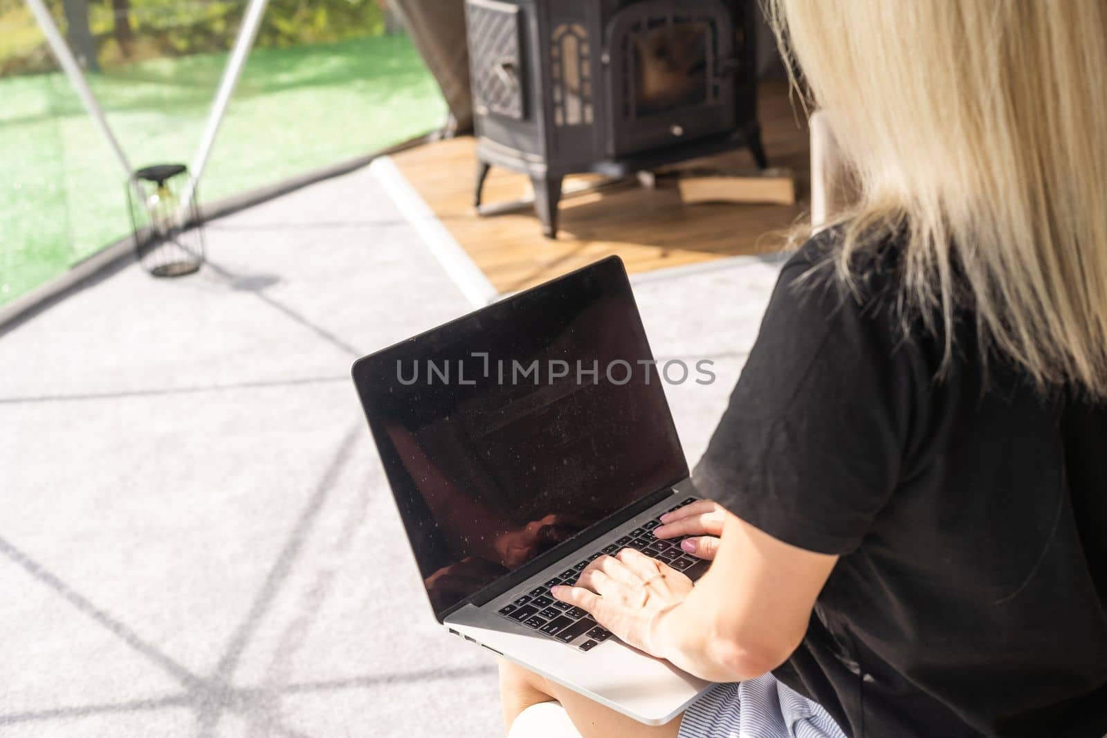 Image of young pleased happy cheerful cute beautiful business woman using laptop computer listening.