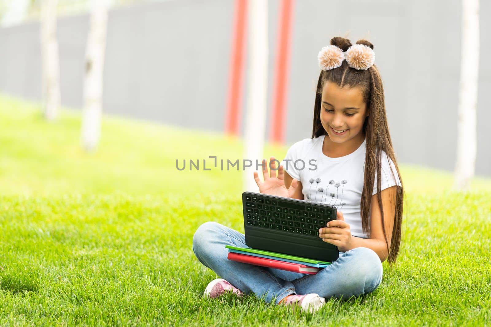 education, free time, technology and internet concept - little student girl with tablet pc.