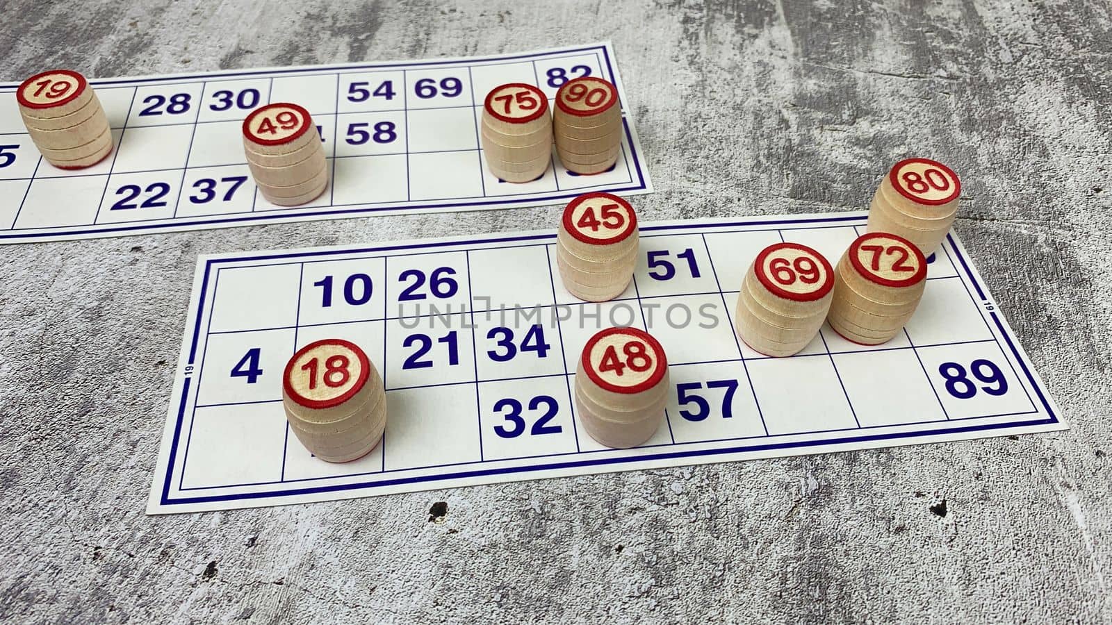 Loto game on the table. Wooden barrels for a board game with family and friends