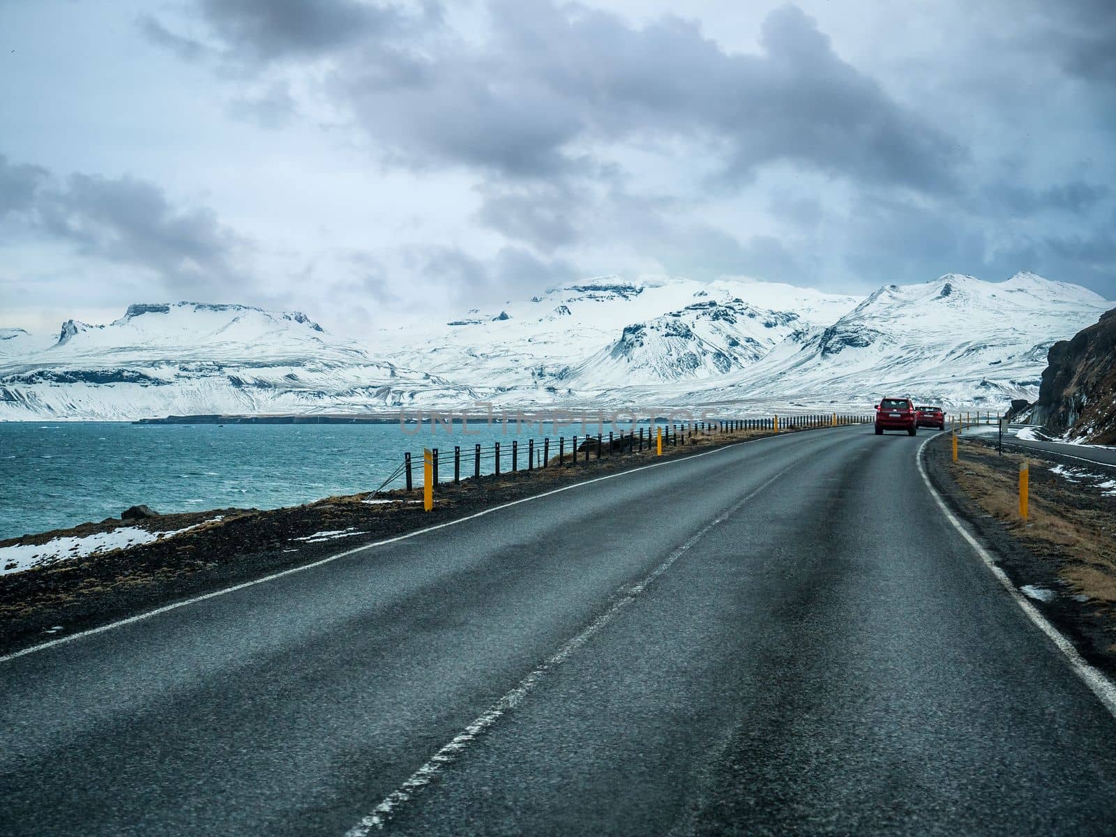 Car riding towards mountains in Iceland in winter by artofphoto