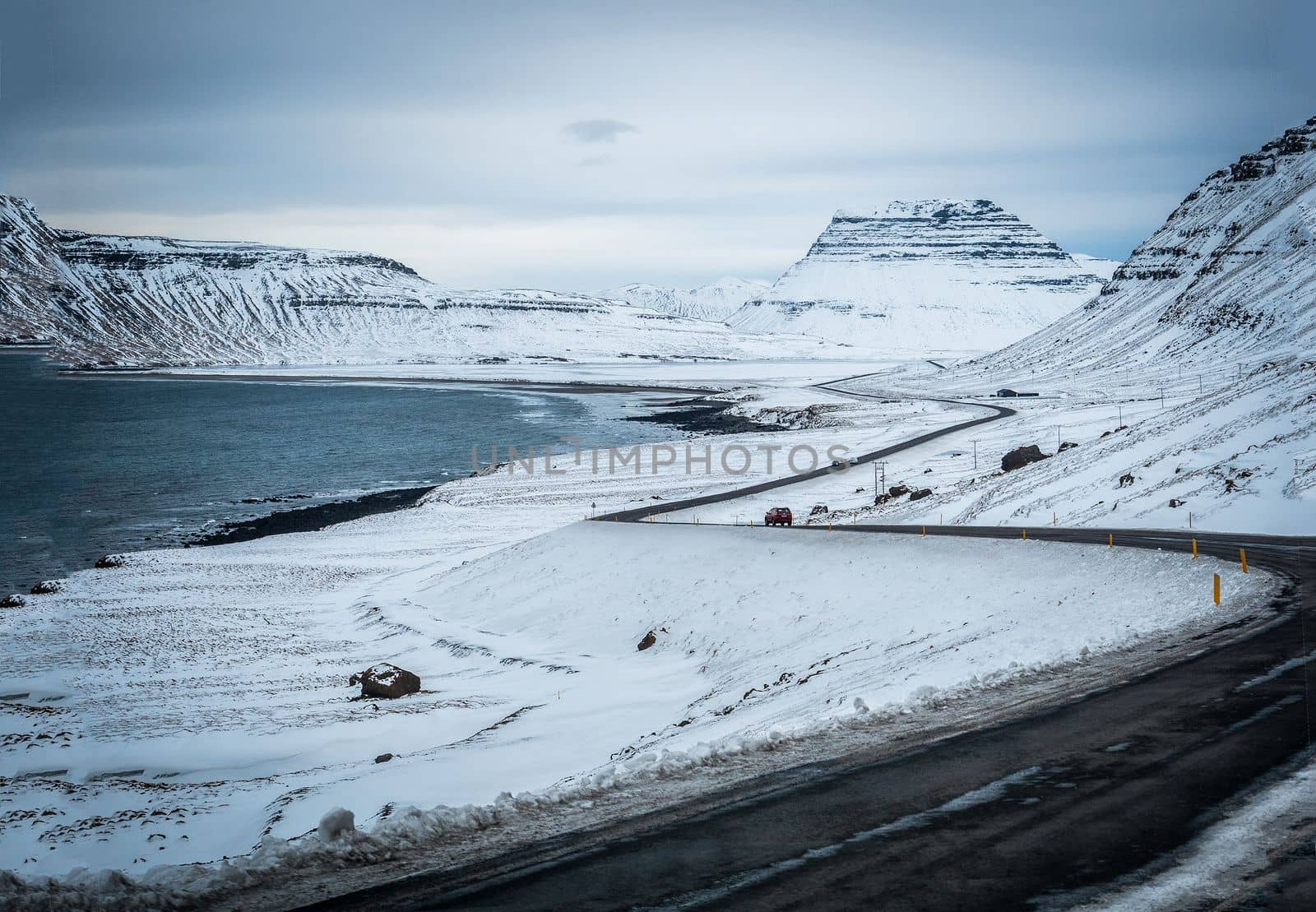 Car riding towards mountains in Iceland in winter by artofphoto