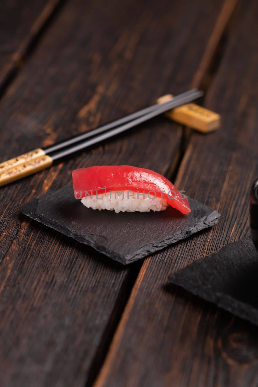 Delicious sushi maguro tuna. Nigiri with tuna on black and wooden background . Traditional Japanese cuisine by Satura86