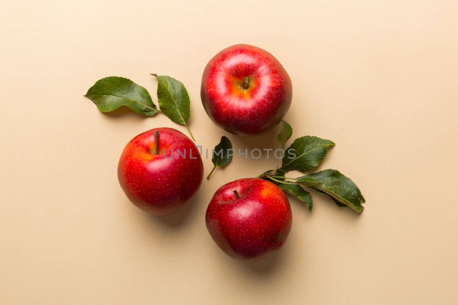 Many red apples on colored background, top view. Autumn pattern with fresh apple above view with copy space for design or text.