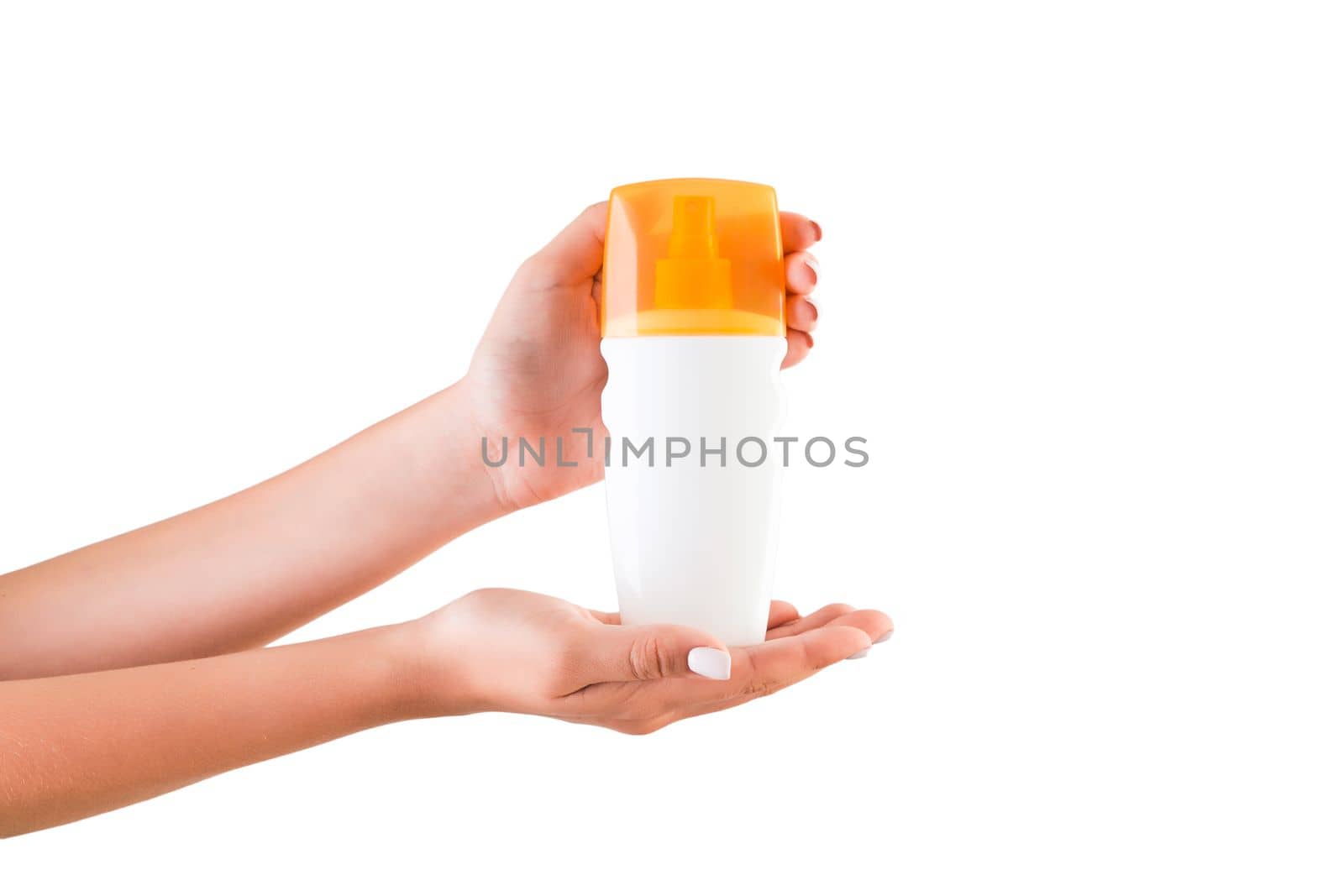 Female hand holding cream bottle of lotion isolated. Girl give cosmetic products on white background.