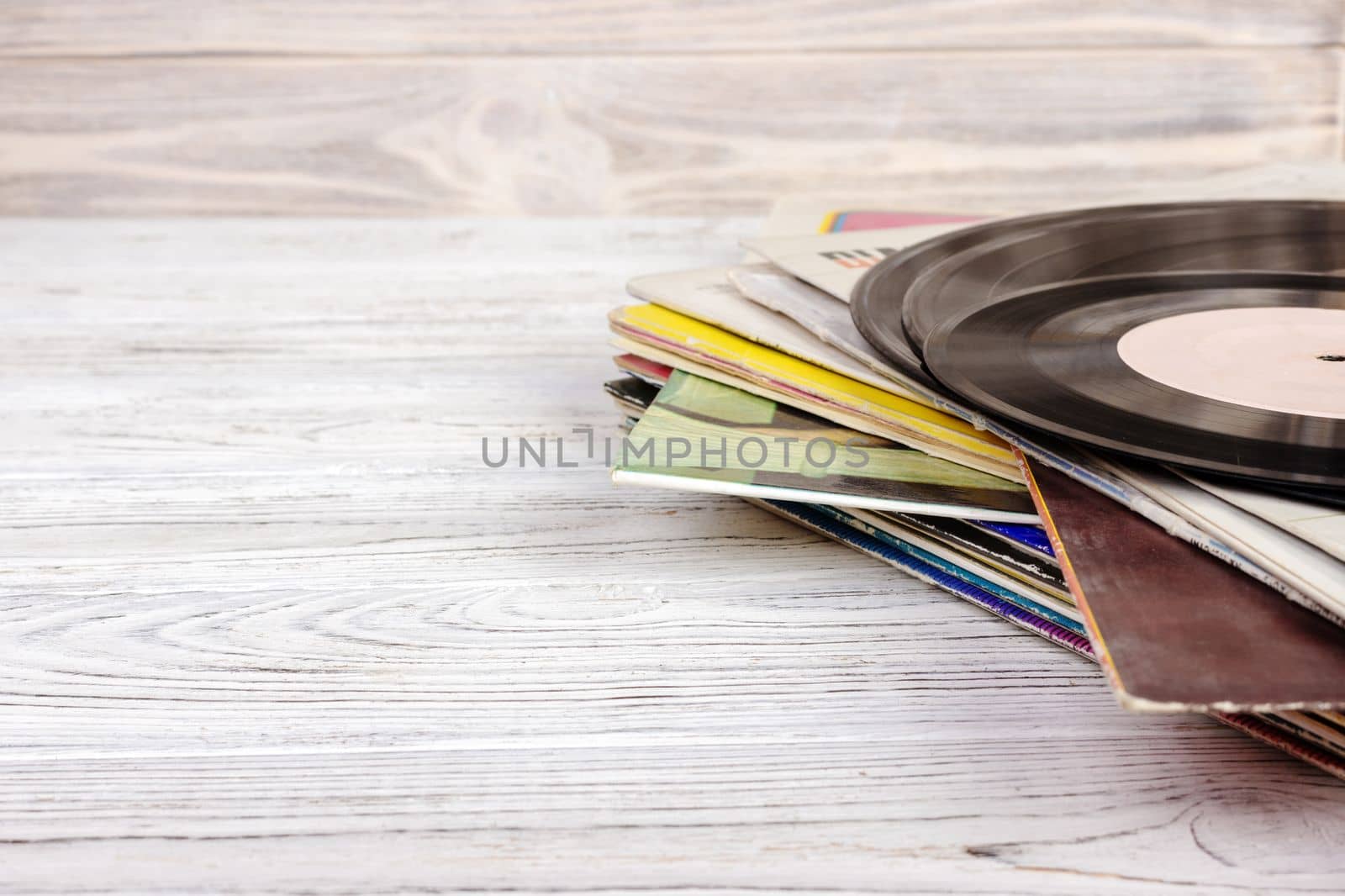 old vinyl record on the wooden table, selective focus and toned image