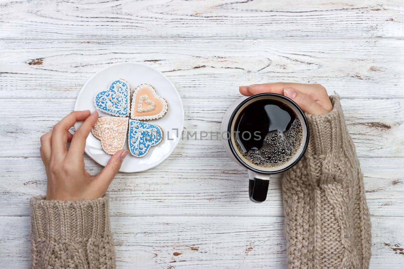 People Hands Showing Heart Shape Cookies with Coffee Cup.