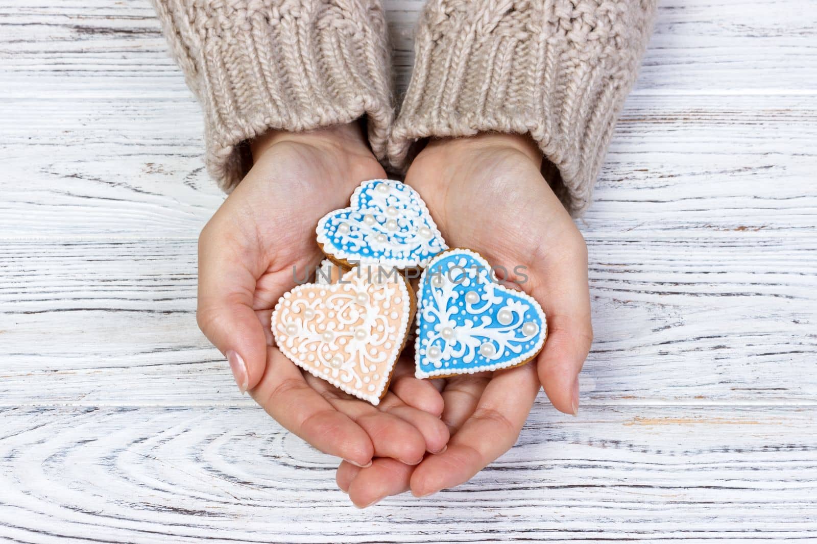 Heart-shaped cookie in woman's hands. holiday cookies