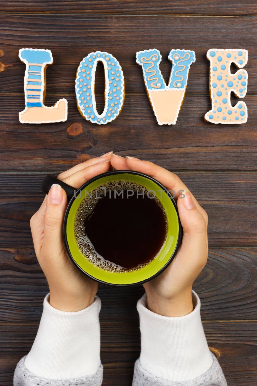 woman with hot cup of coffee, with biscuits. love concept. Love word with coffee.