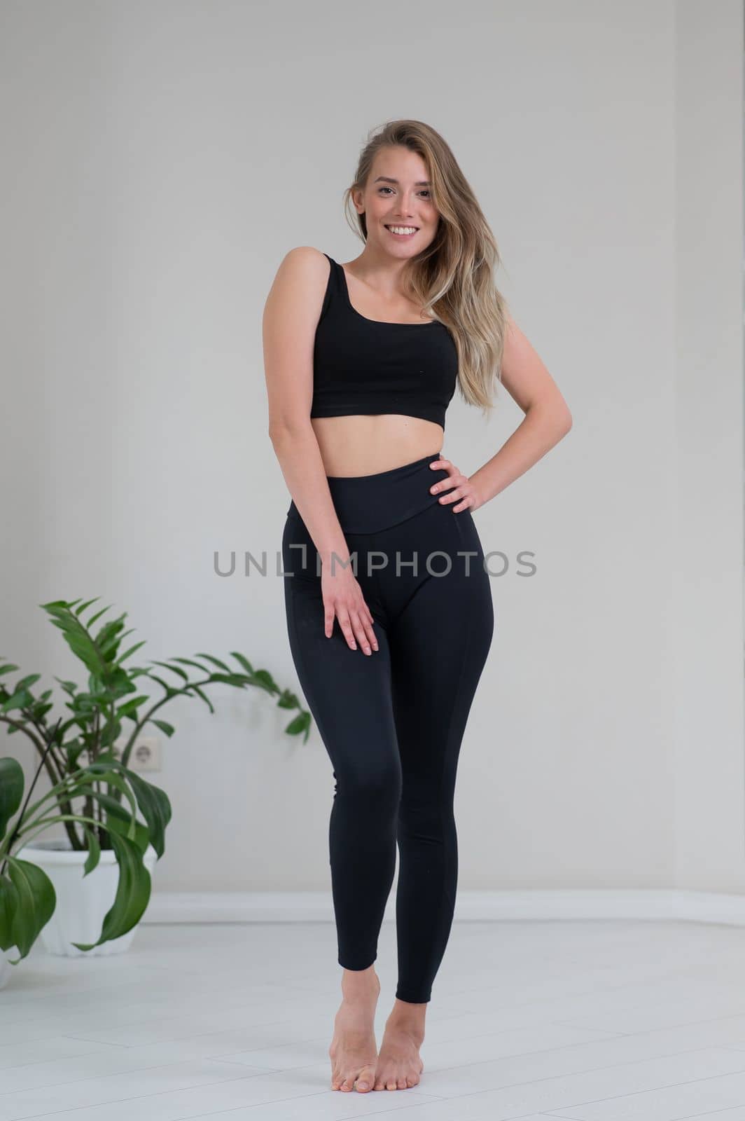 Full length portrait of a beautiful caucasian woman in black sportswear. by mrwed54