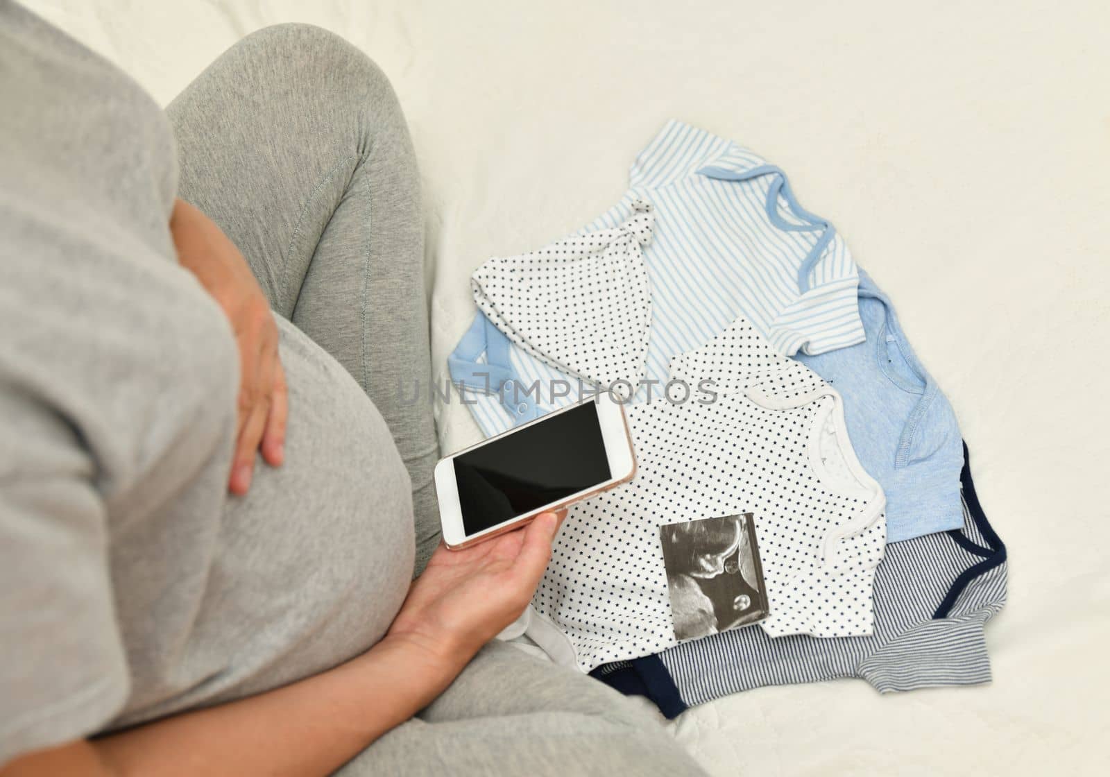 Pregnant woman takes pictures of ultrasound image of her baby