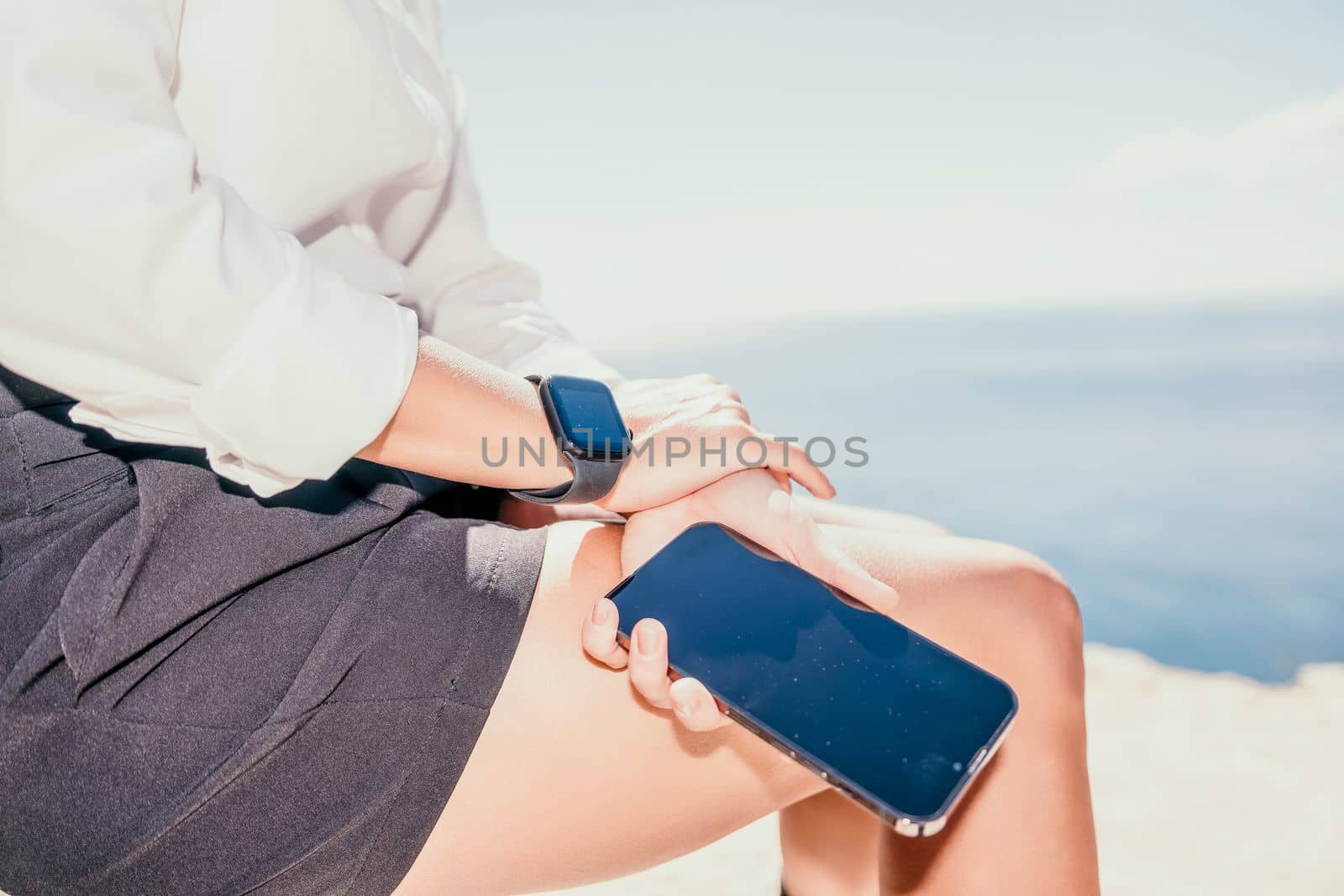 Happy girl doing yoga with laptop working at the beach. beautiful and calm business woman sitting with a laptop in a summer cafe in the lotus position meditating and relaxing. freelance girl remote work beach paradise