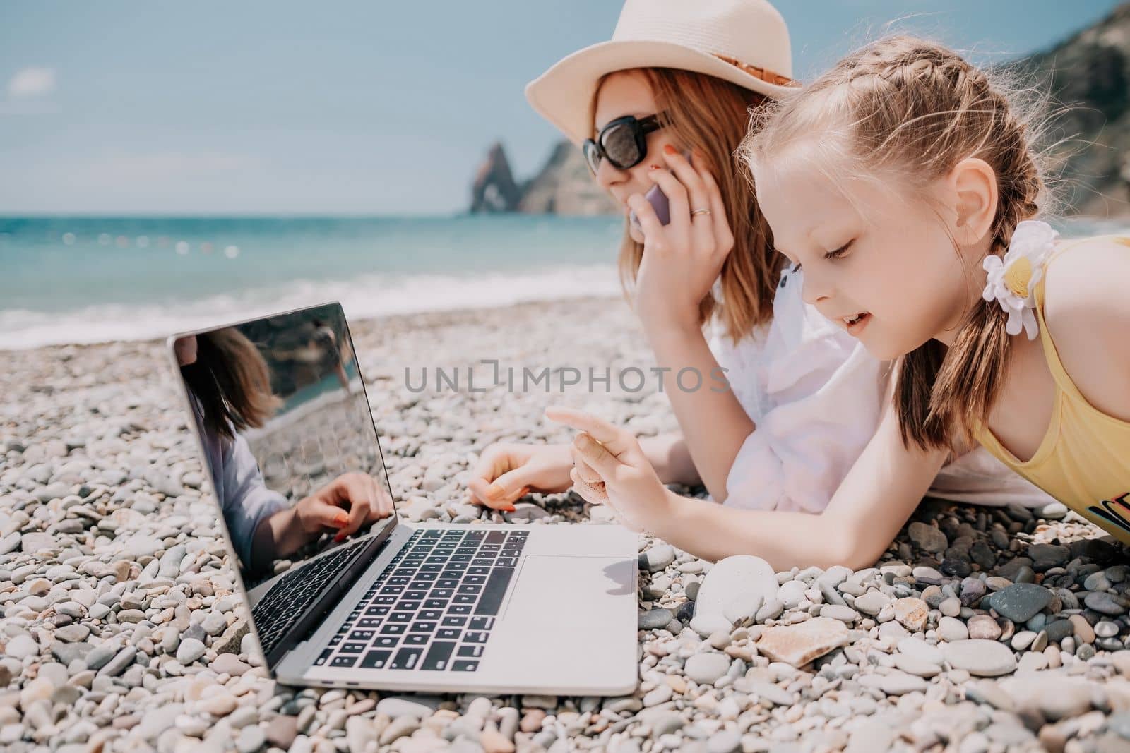 Woman sea laptop. Business woman in yellow hat working on laptop by sea. Close up on hands of pretty lady typing on computer outdoors summer day. Freelance, digital nomad, travel and holidays concept.