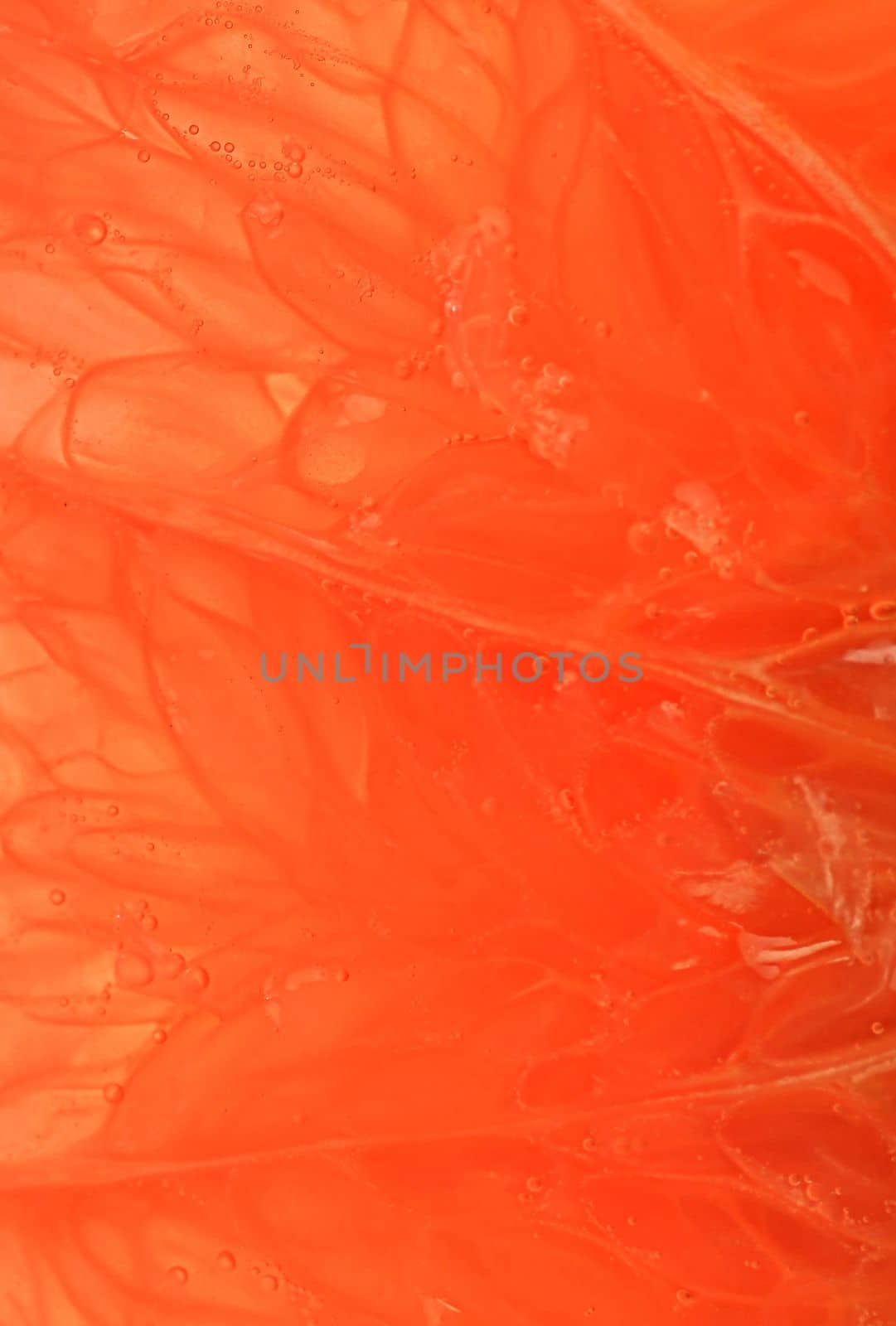 Grapefruit close-up. Slice of blood red ripe grapefruit. Texture of red juicy grapefruit. Macro vertical image by roman_nerud