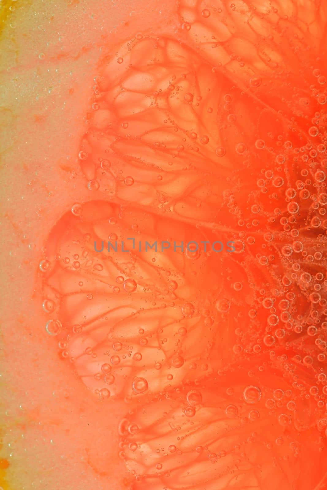 Grapefruit close-up. Slice of blood red ripe grapefruit. Texture of red juicy grapefruit. Macro vertical image by roman_nerud