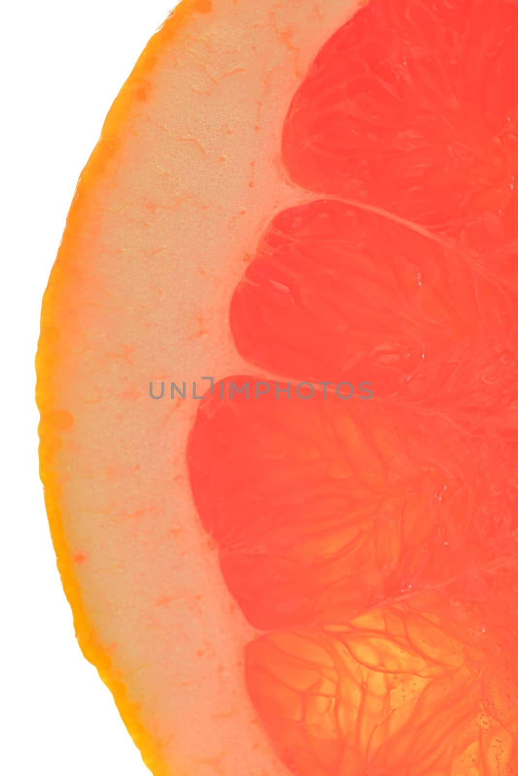Fresh organic grapefruit slice on white background. Grapefruit close-up. Slice of blood red ripe grapefruit. Texture of red juicy grapefruit. Macro verical image by roman_nerud
